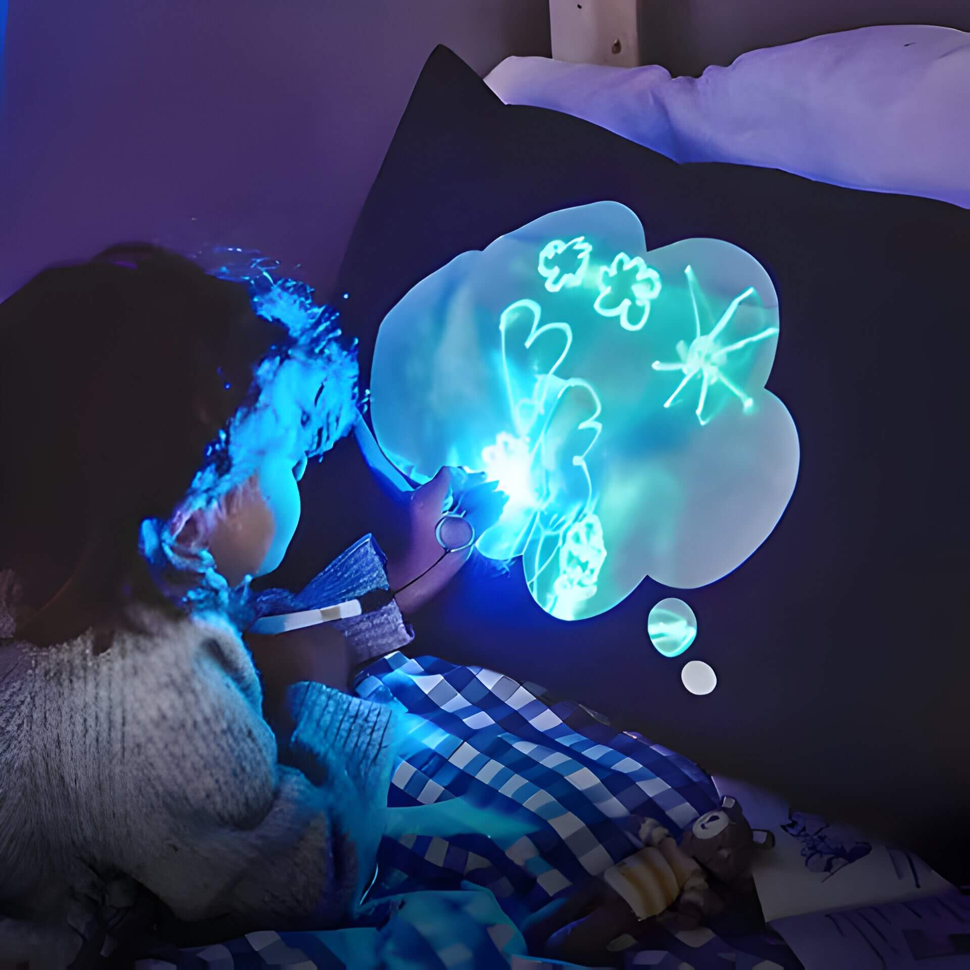a child drawing on a glow in the dark pillow