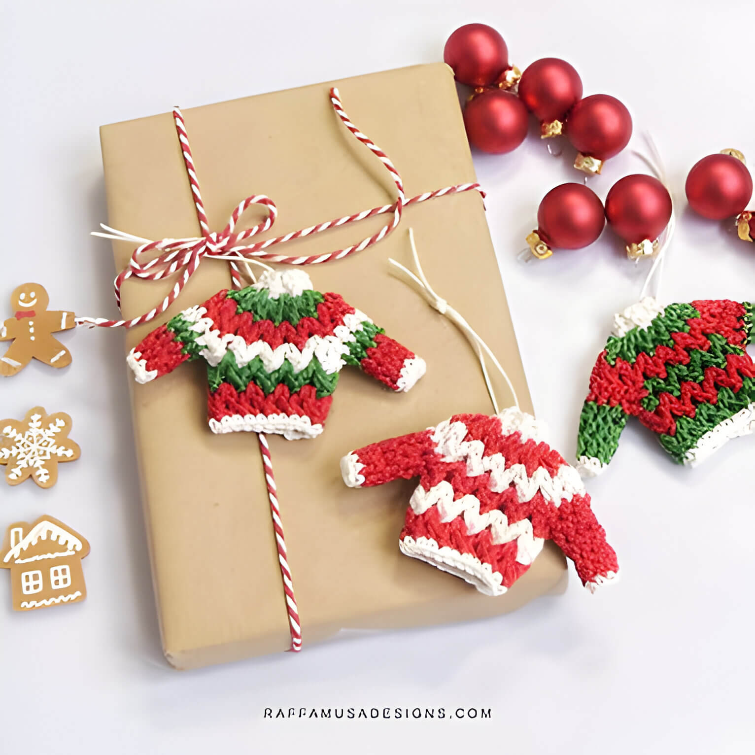 a gift wrapped in brown paper with crochet christmas jumper tags
