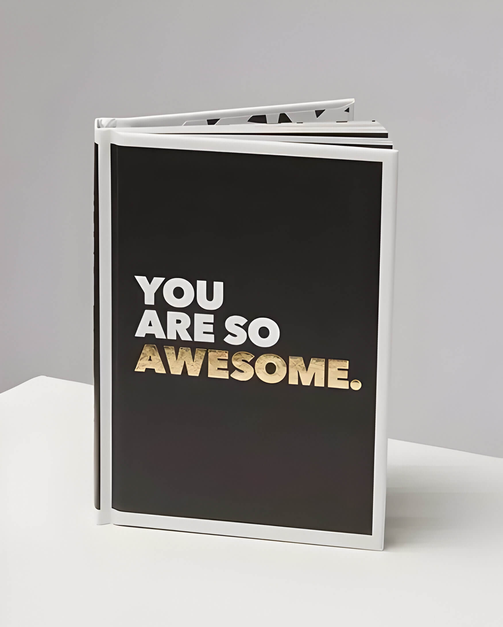 a black book with the text "you are so awesome" in white and gold text
