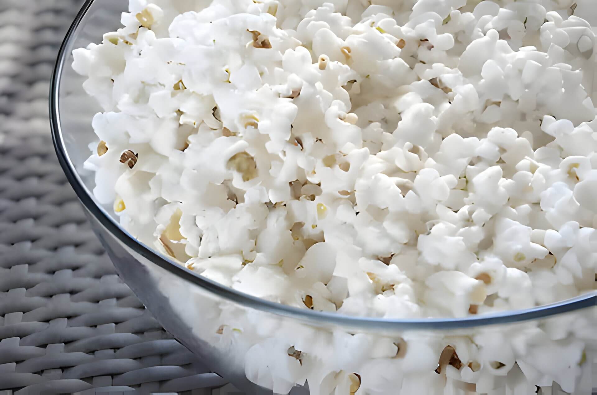 a glass bowl of popcorn