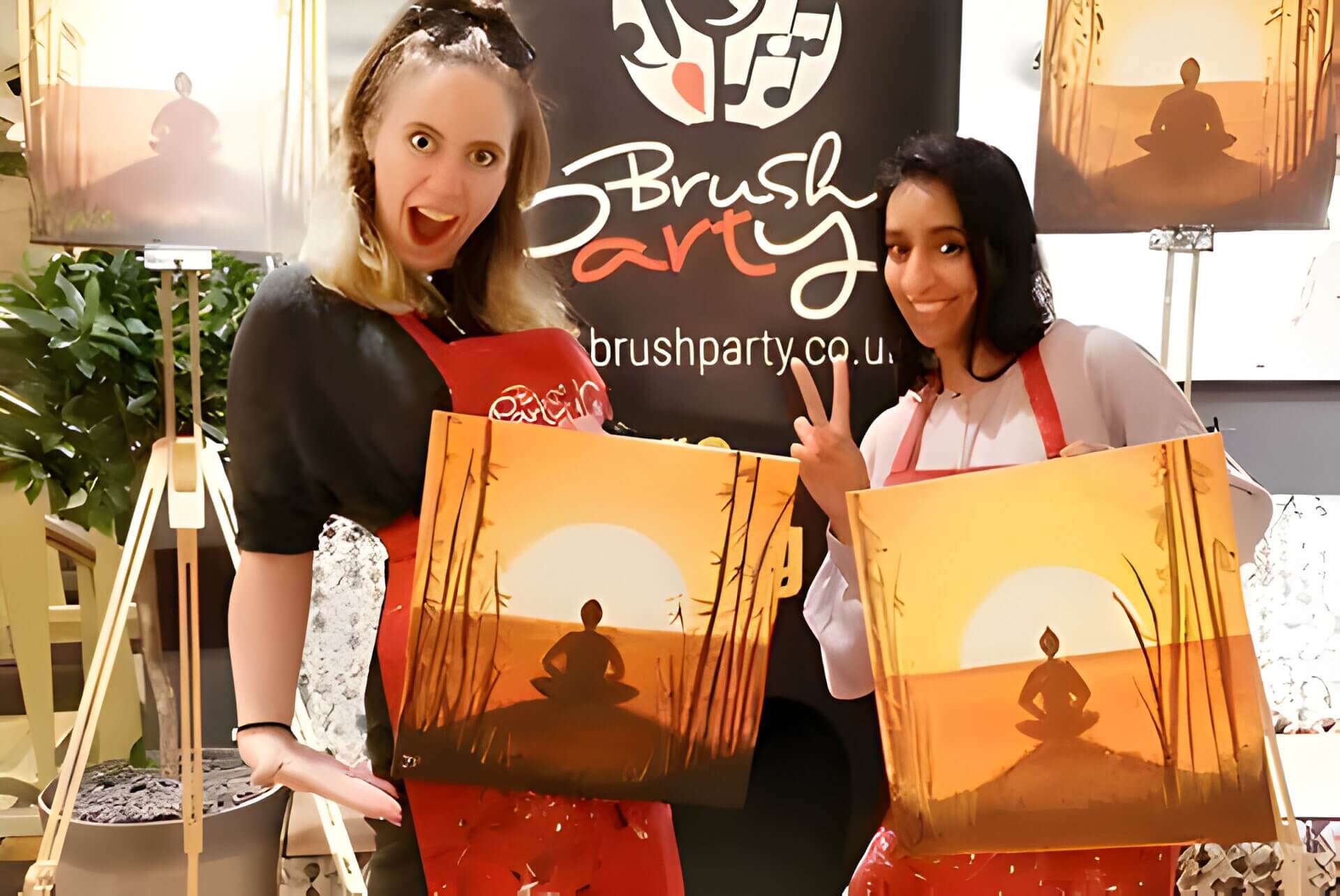 A couple with paintings they have created in a art class