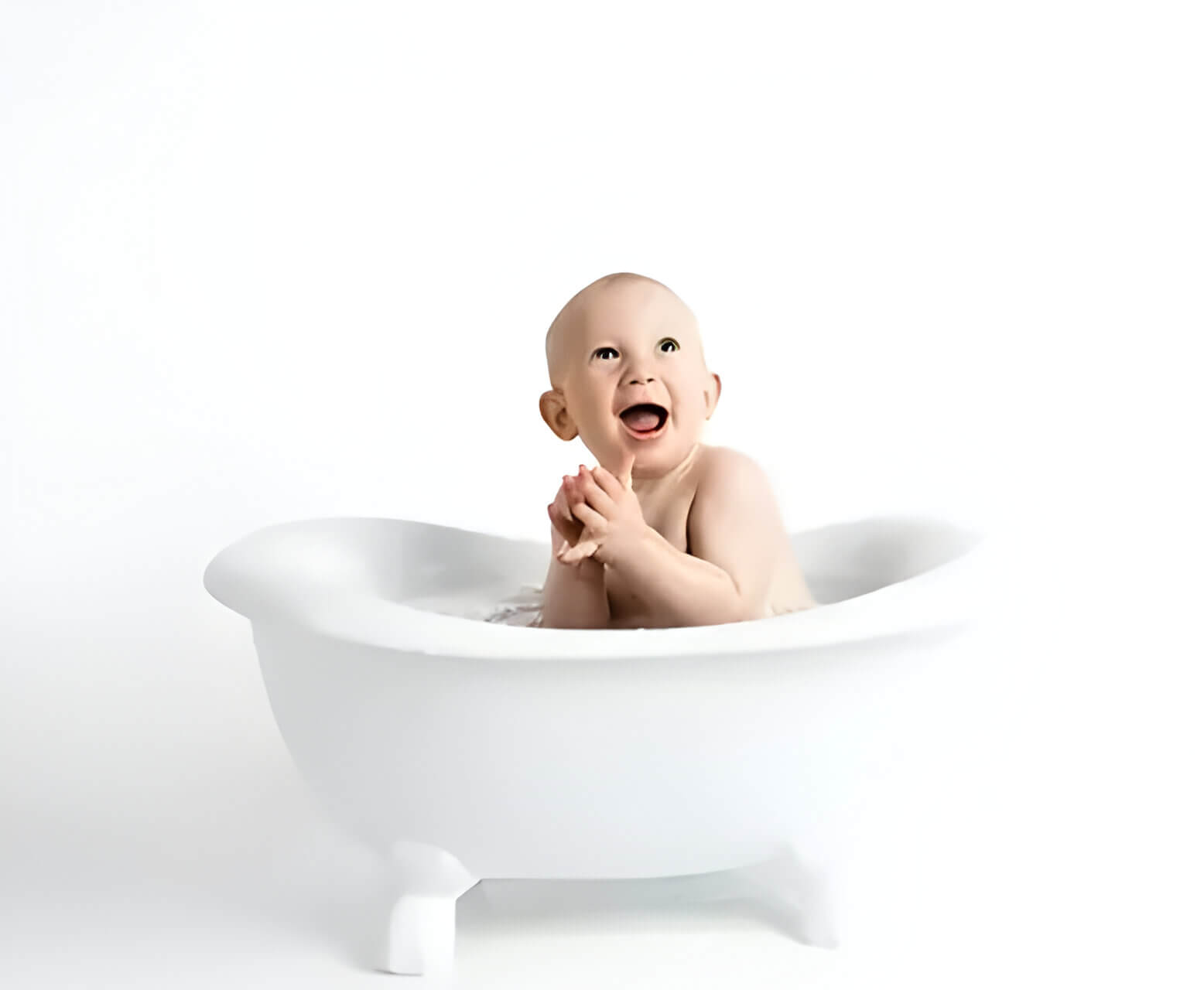A happy baby in a white baby bath