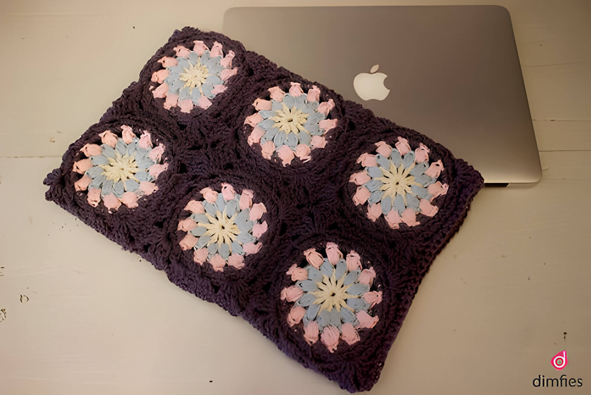 a brown and pink crochet laptop case