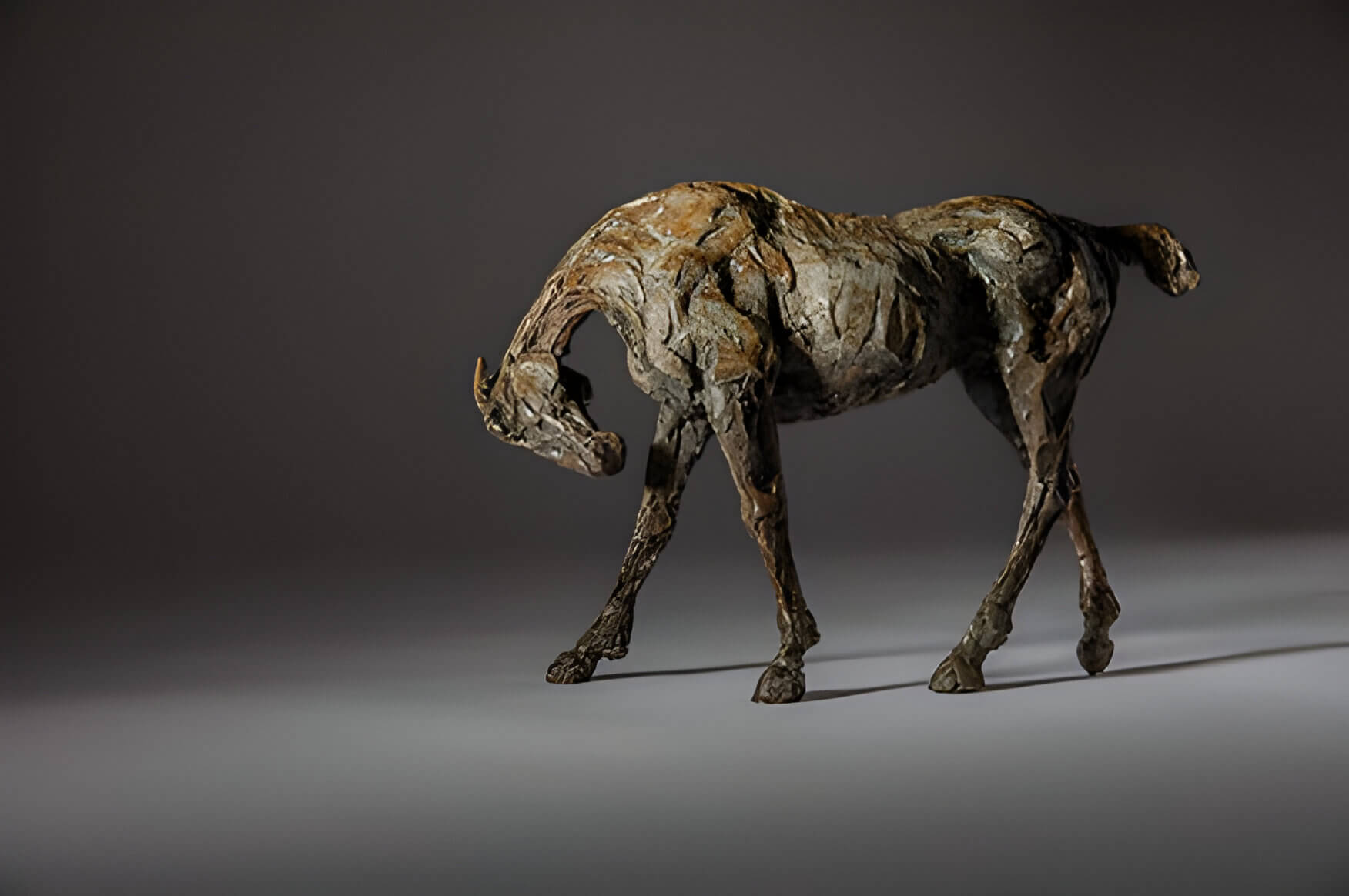 a bronze sculpture of a race horse
