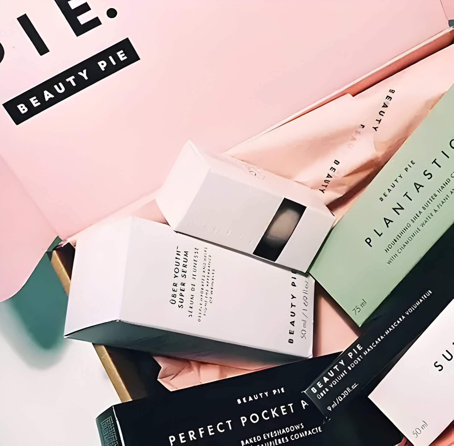 the contents of a beauty subscription box. items are in pale pink boxes