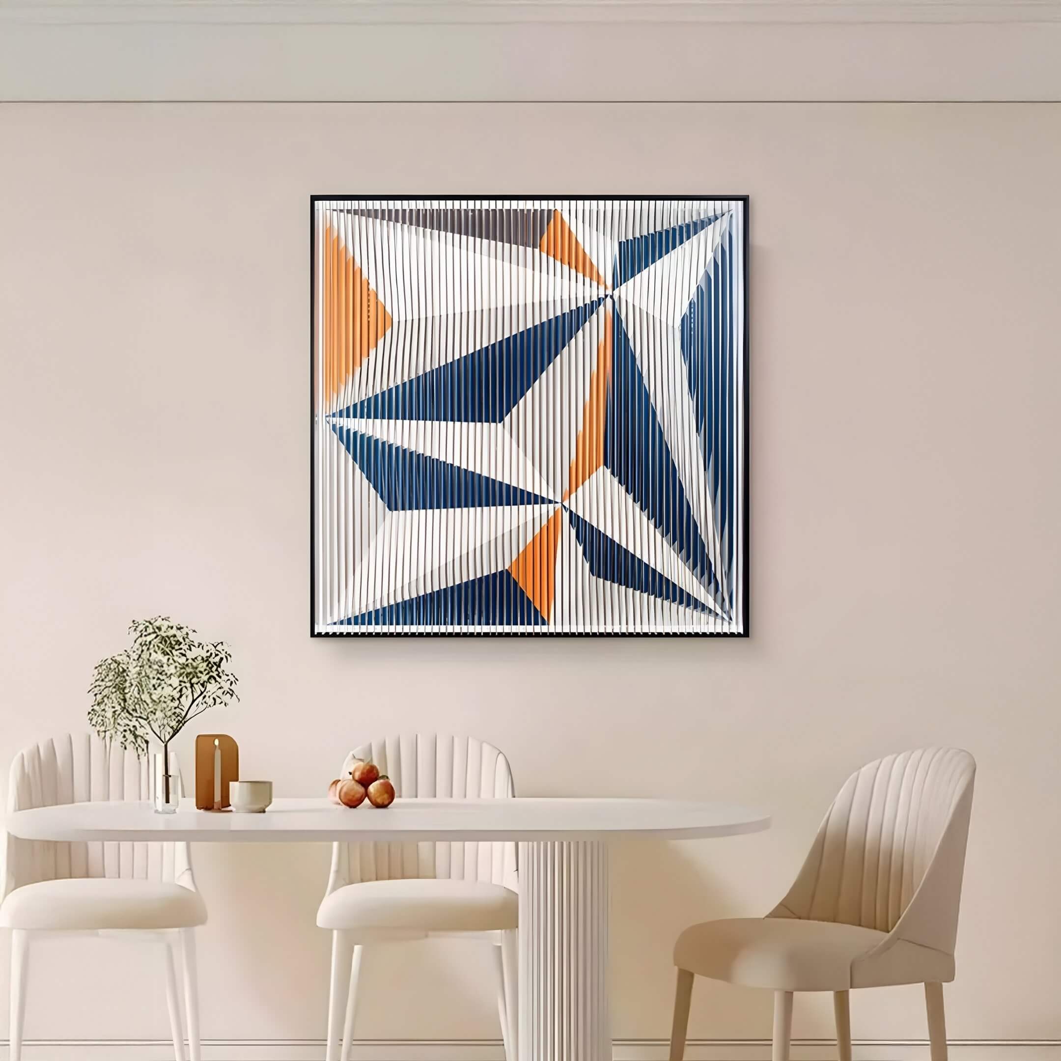 Modern geometric 3D wall art with blue, orange, and white angular shapes and striped acrylic texture, framed and displayed in a minimalist dining room.
