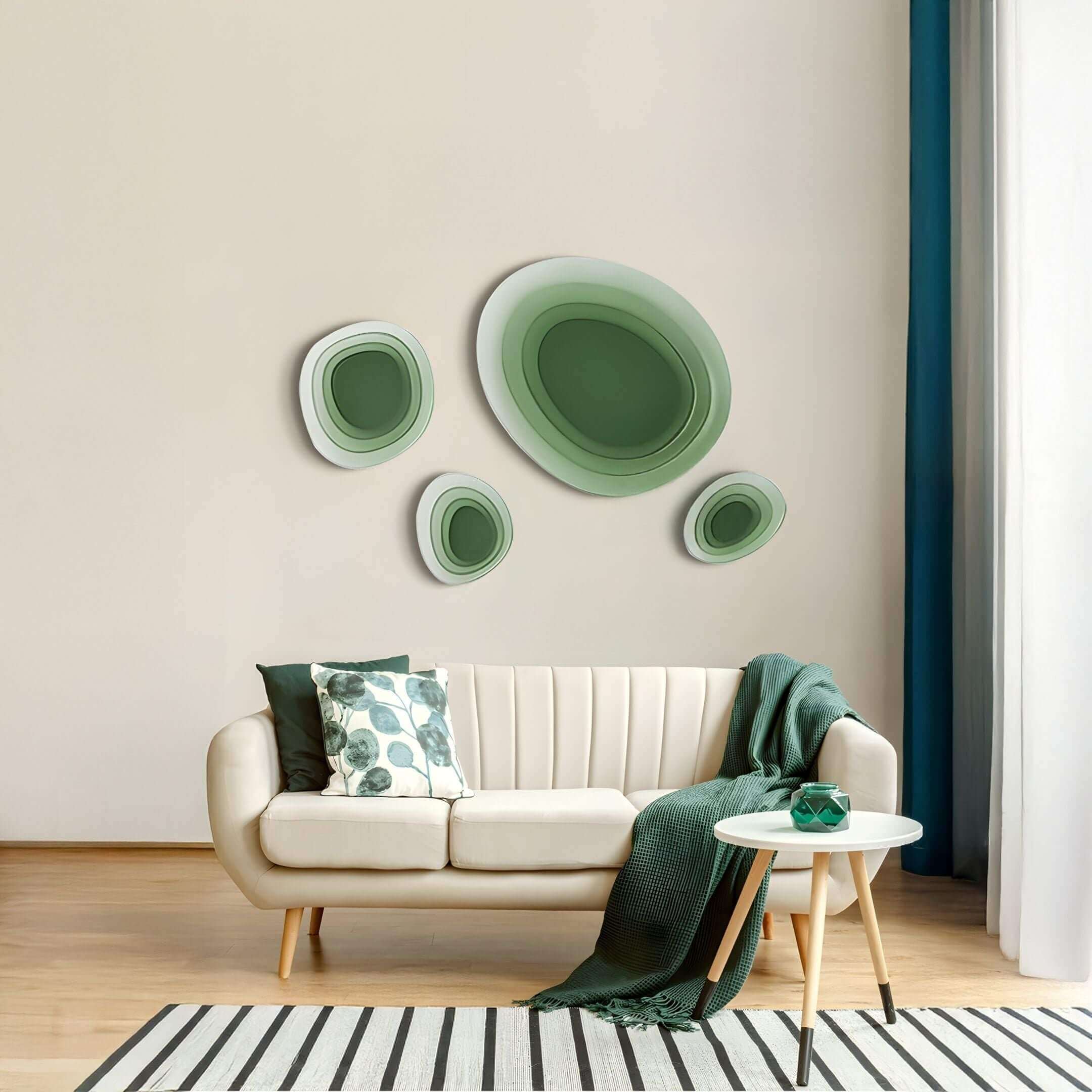 A modern living room with the Nuvora Green Gradient Cluster 3D Acrylic Wall Art featuring layered organic oval forms in soft green tones, displayed above a cream sofa with green cushions and minimal decor.