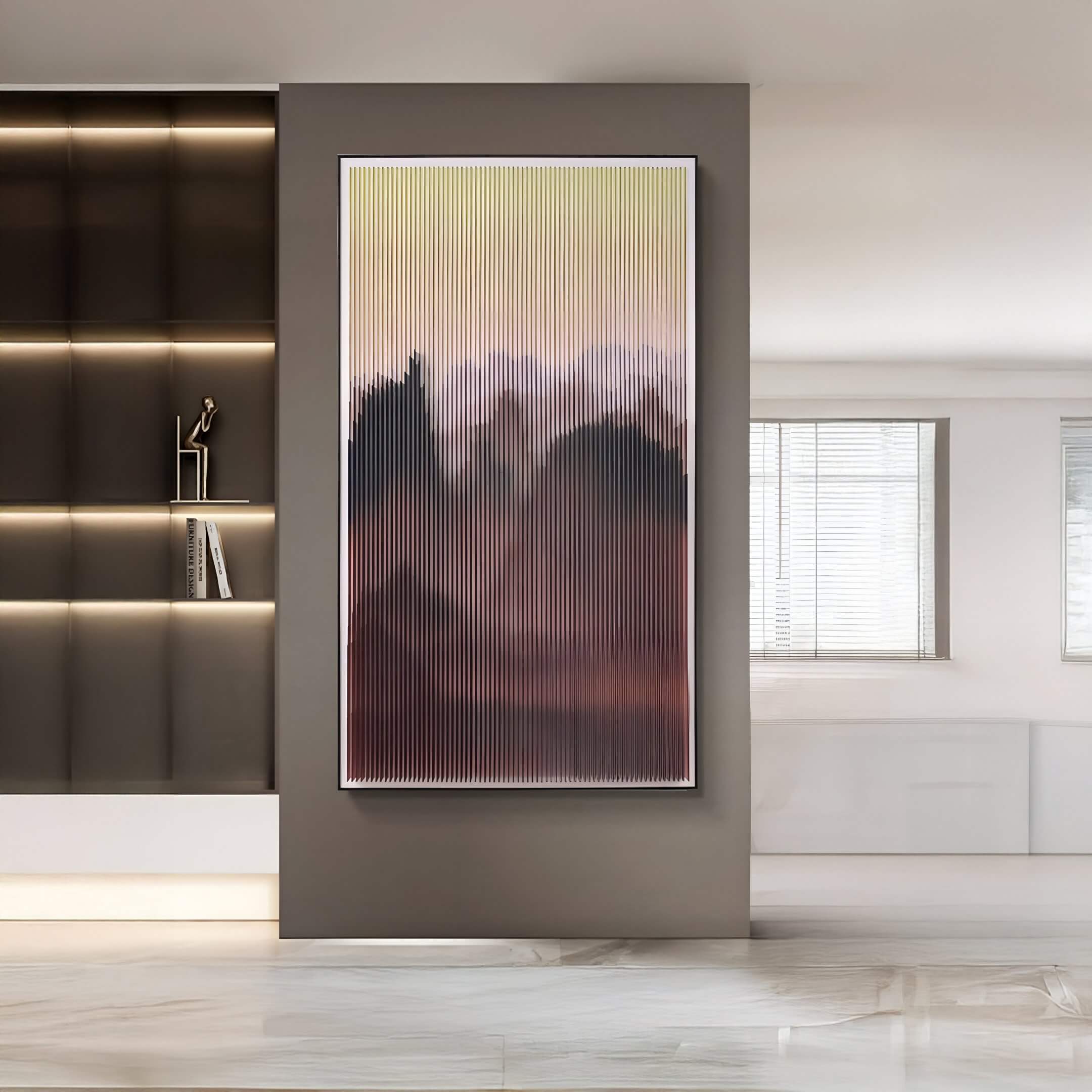 Vertical abstract acrylic 3D wall art with gradient tones of yellow, pink, and deep burgundy, framed in white, displayed in a modern minimalist interior with grey walls and marble flooring.