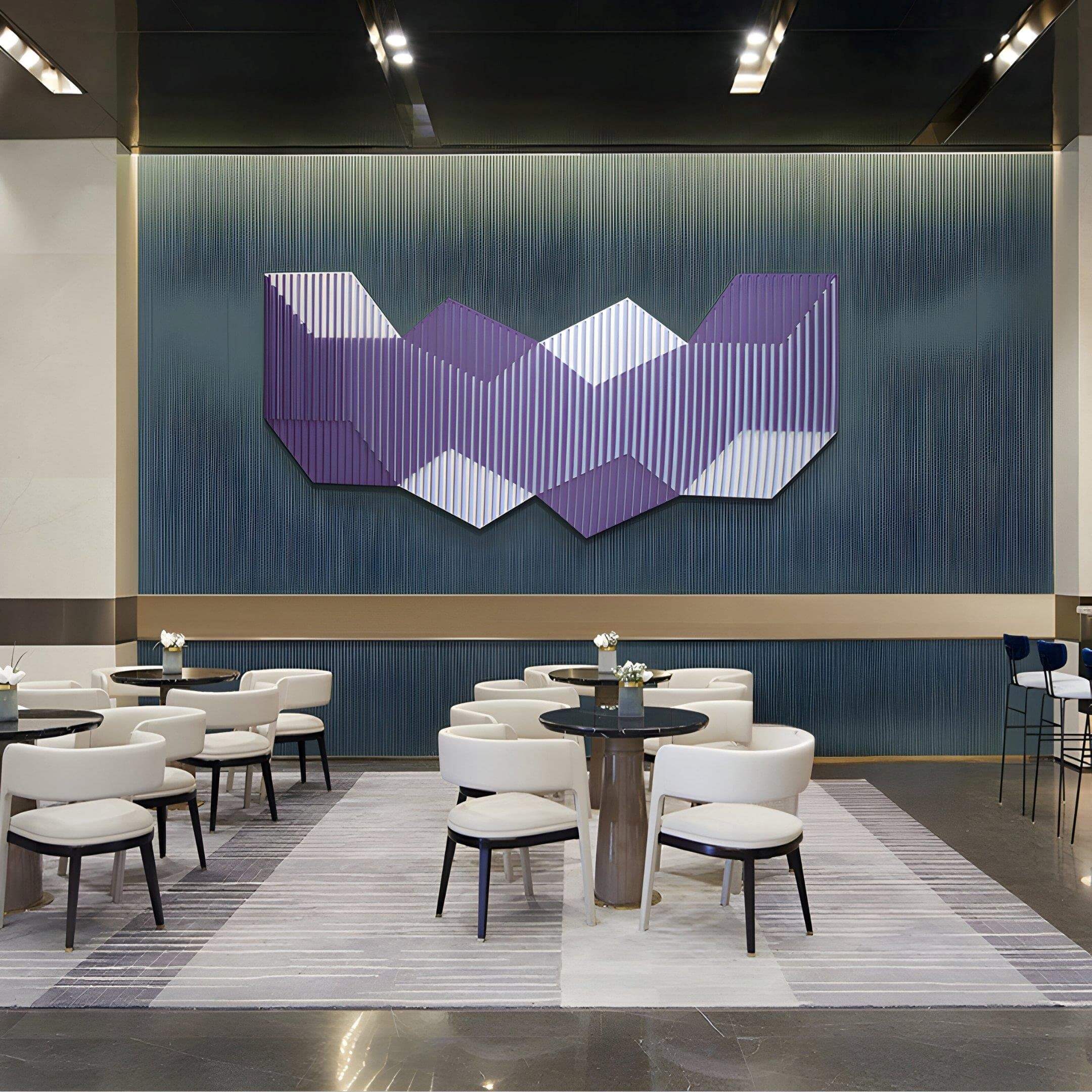 A modern lounge with white chairs and round tables on a striped rug features the Vertex Lavender & Soft Lilac Ridge Acrylic & Wood Carving 3D Wall Art by Giant Sculptures and a blue gradient accent wall in the background.