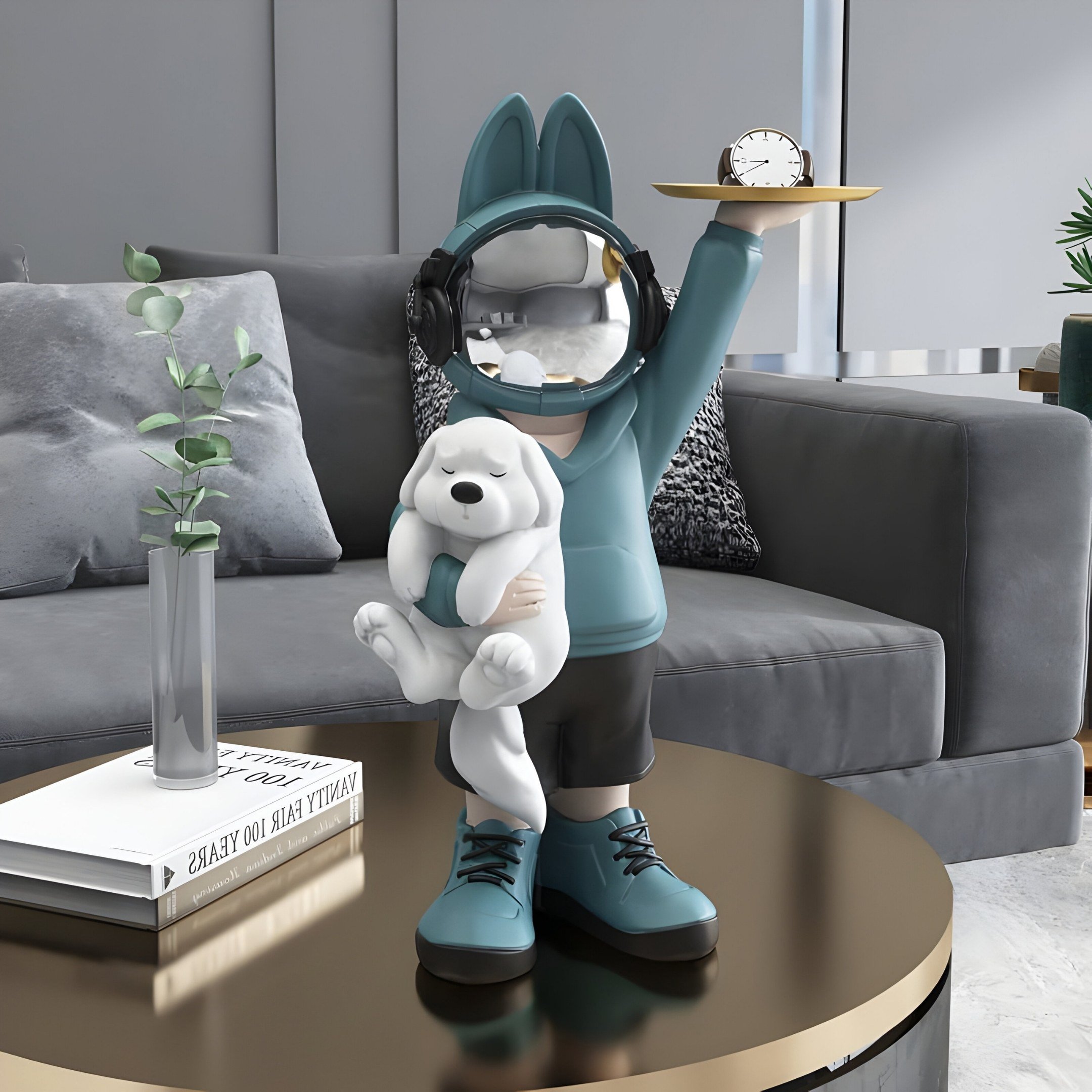 In a contemporary living room, the whimsical Blue Astronaut Bunny Pup Butler Figure by Giant Sculptures stands at 44cm tall. This playful resin figure features a child in teal with a mirrored face, headphones, and holding a white fluffy cat, positioned next to the tall sofa on a round table.