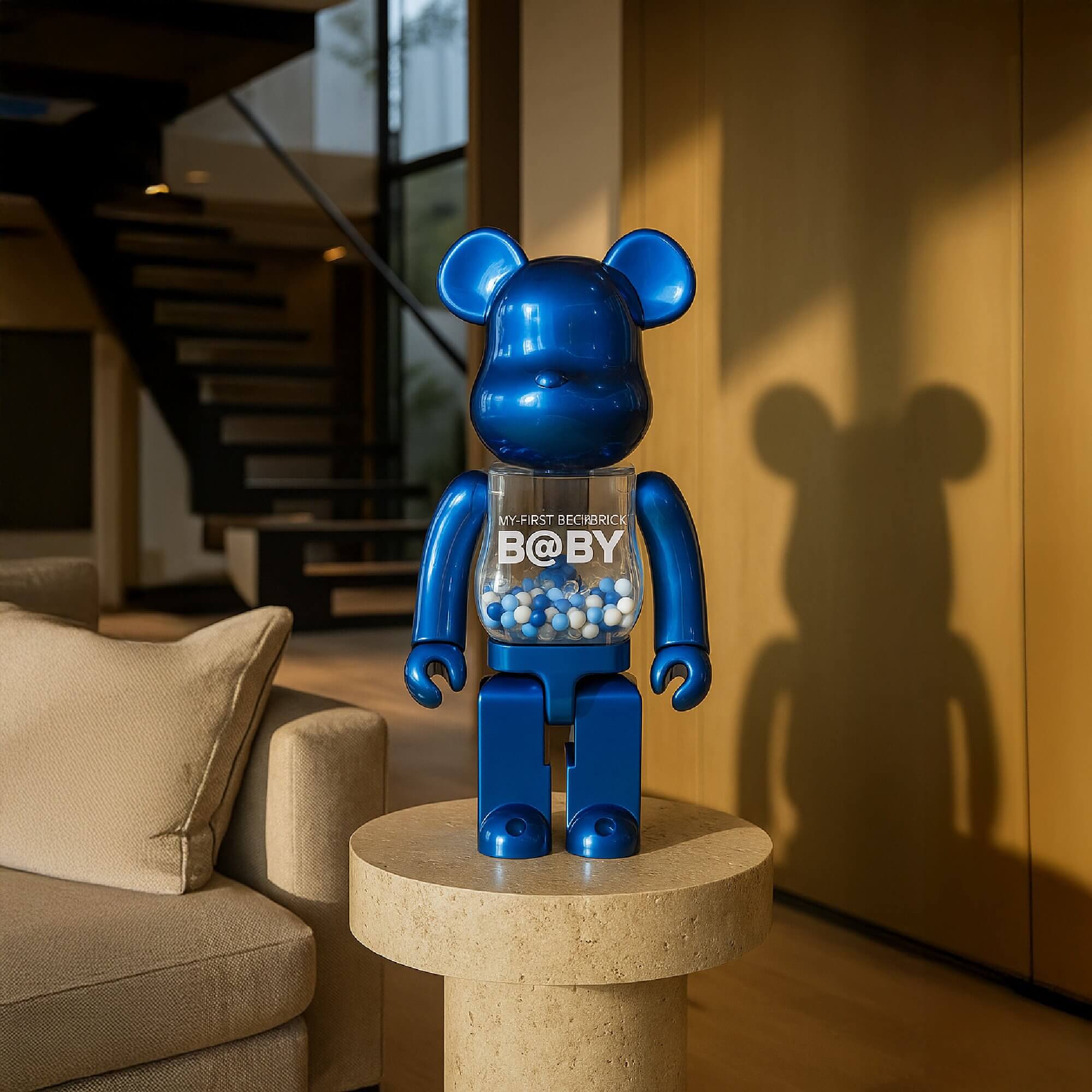 A 70cm Sapphire Blue Beads Bear Sculpture displayed on a stone pedestal in a modern living room, featuring a glossy blue body with a transparent torso filled with blue and white beads.