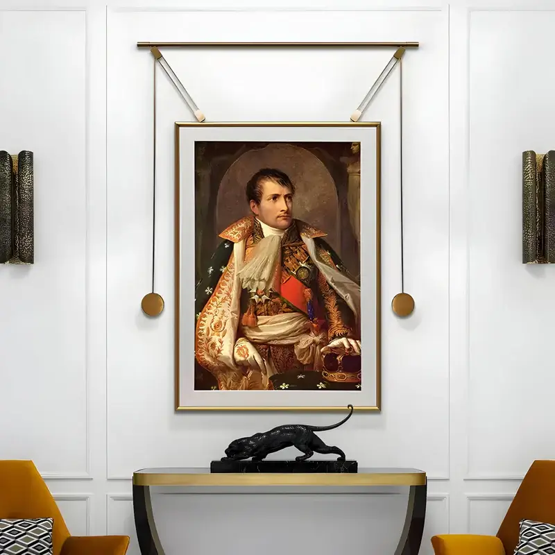 A luxurious setting displaying a framed portrait of a historical figure, elegantly suspended with a gold hanging system, accompanied by sophisticated decor.