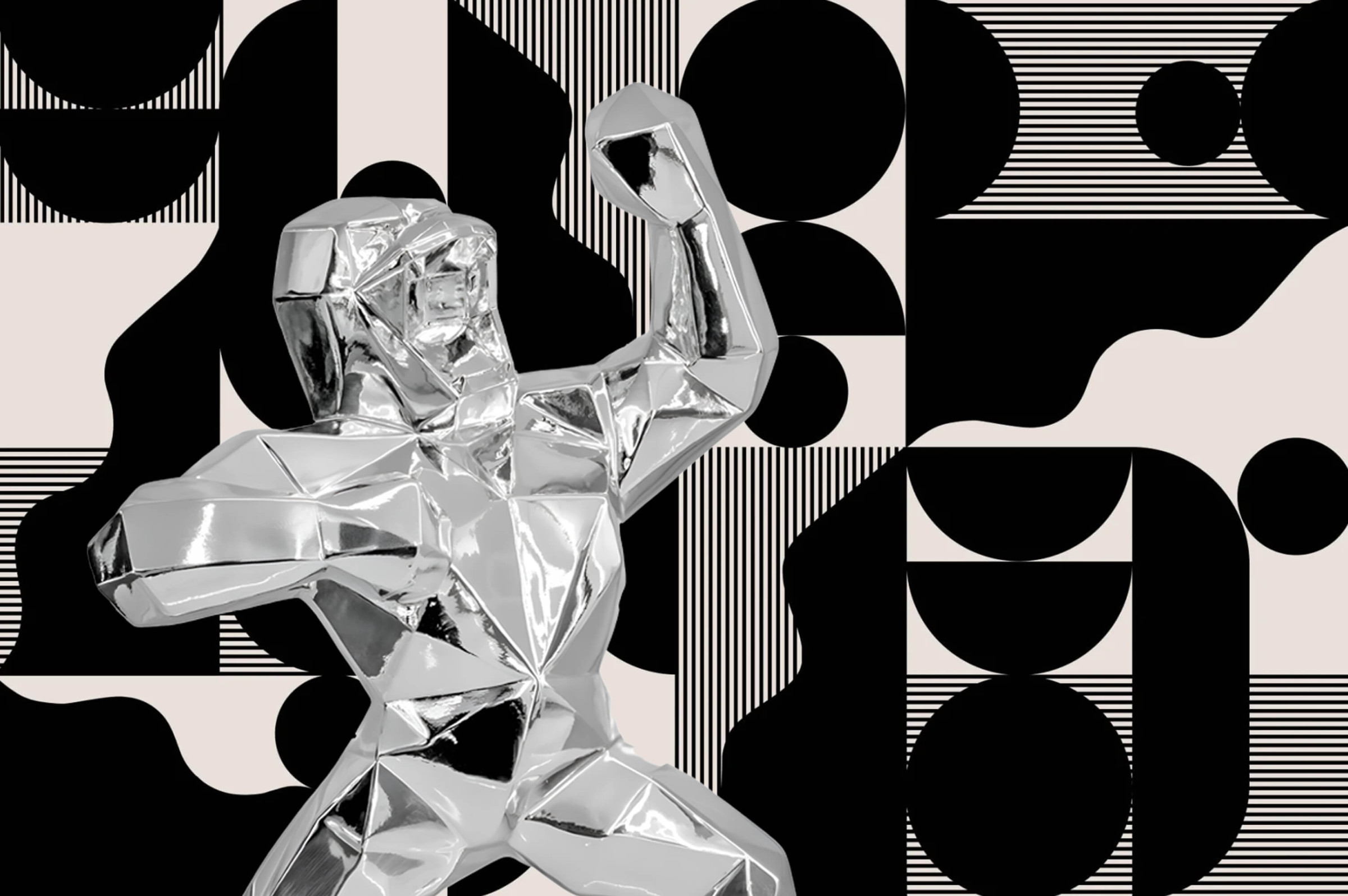 Polished silver geometric gorilla sculpture with angular faceted surfaces, posed with raised fists against a black-and-white abstract geometric background.