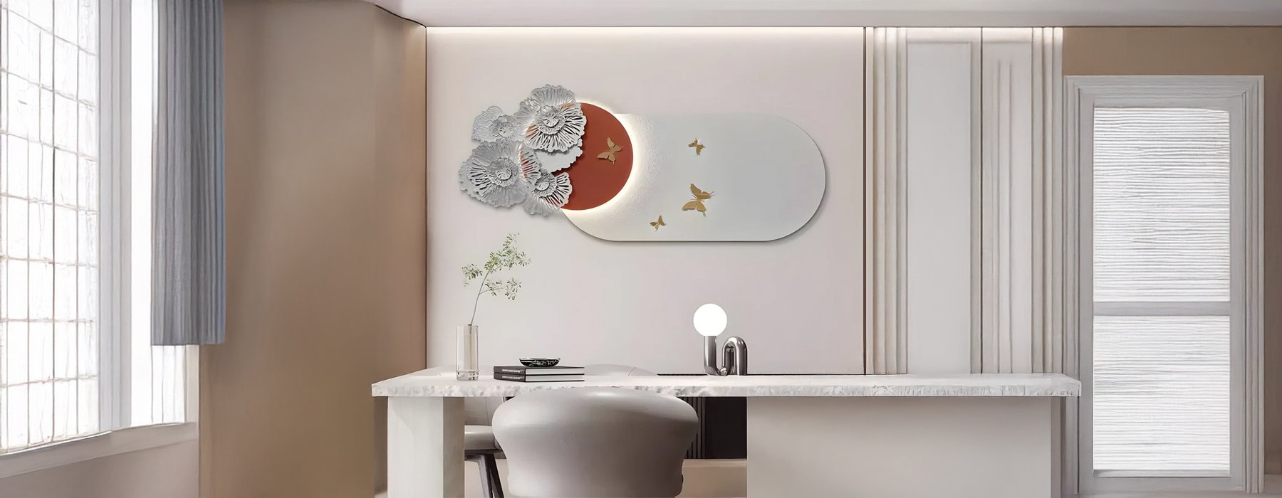 A stylish home office setup featuring a white desk, a modern chair, and an abstract wall art piece with a curved mirror, metallic floral details, and golden star accents.