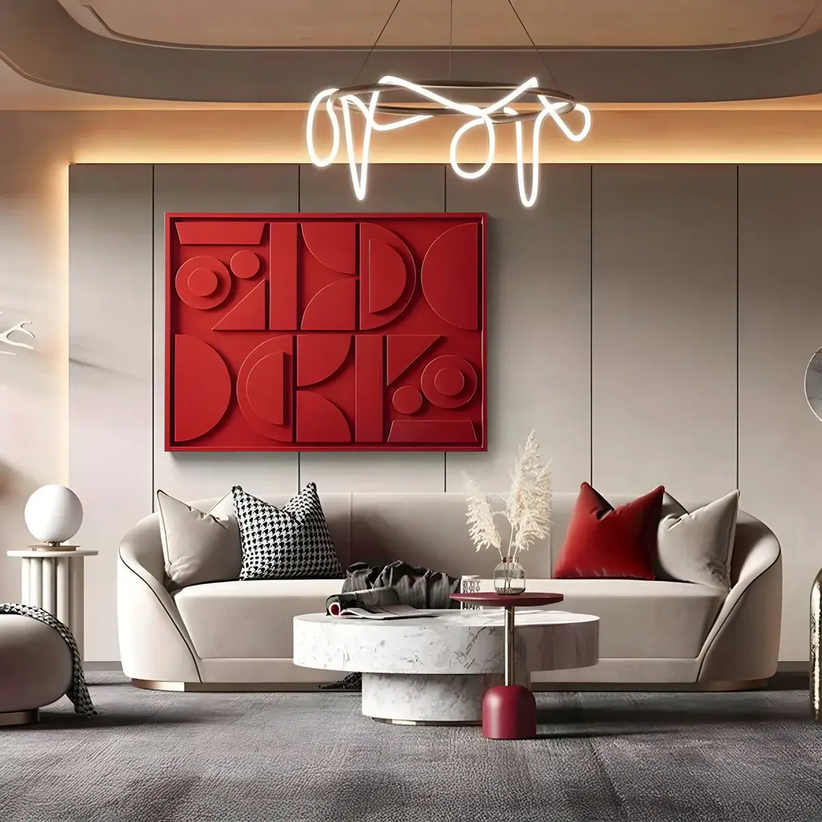 A modern living room with a neutral-toned curved sofa, marble coffee table, and a bold red three-dimensional geometric artwork. A sculptural LED chandelier adds a sophisticated touch.