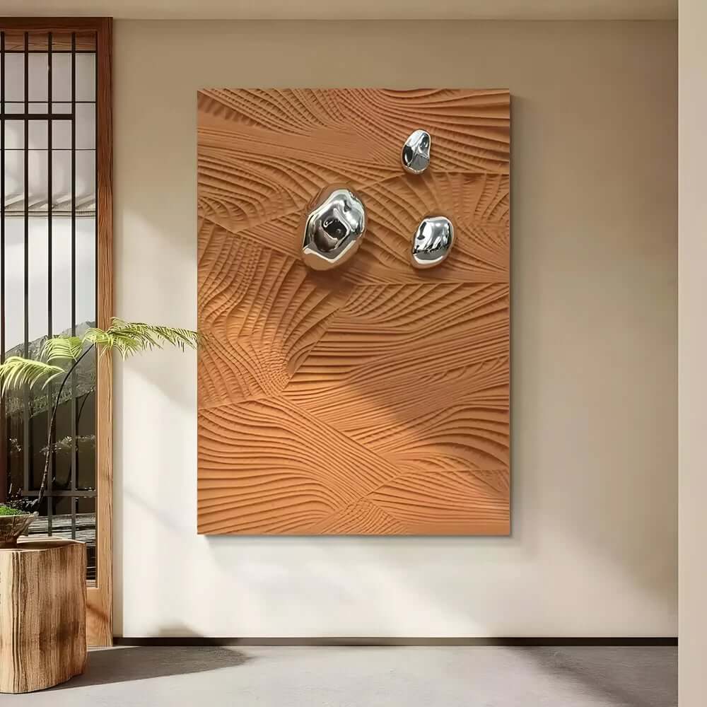 Modern wall art featuring a textured wooden panel with abstract wave-like patterns and three metallic chrome accents mounted on its surface, displayed in a minimalist interior.