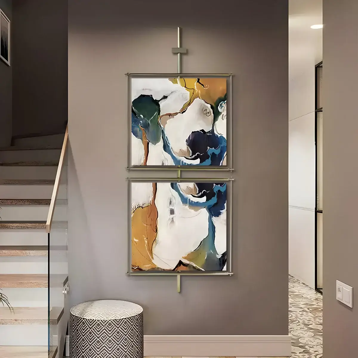 A stylish hallway with two vertically framed abstract paintings in deep blue and gold tones, enhancing the contemporary aesthetic.