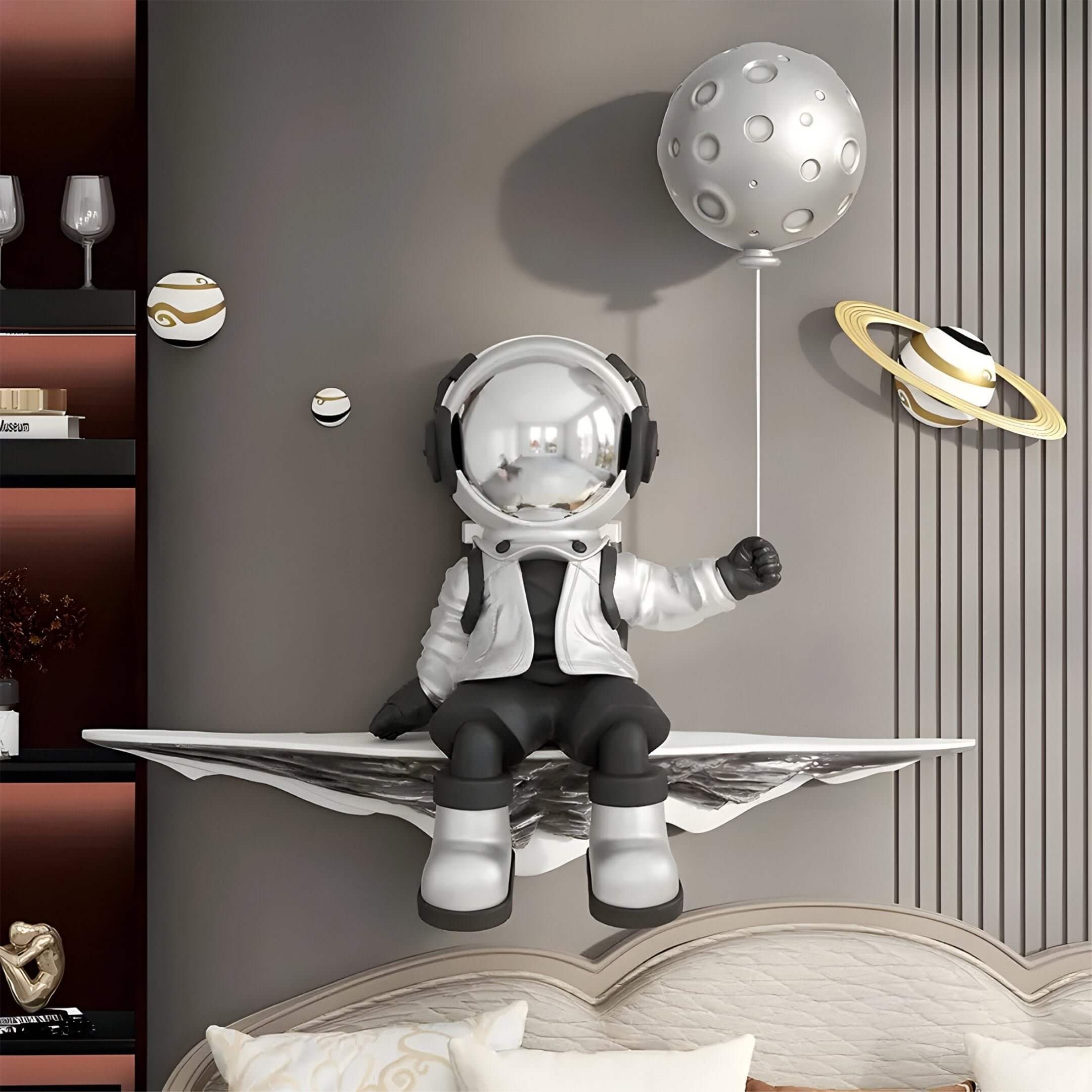 Modern bedroom with 3D astronaut figure holding a moon balloon, surrounded by small planet wall decor.