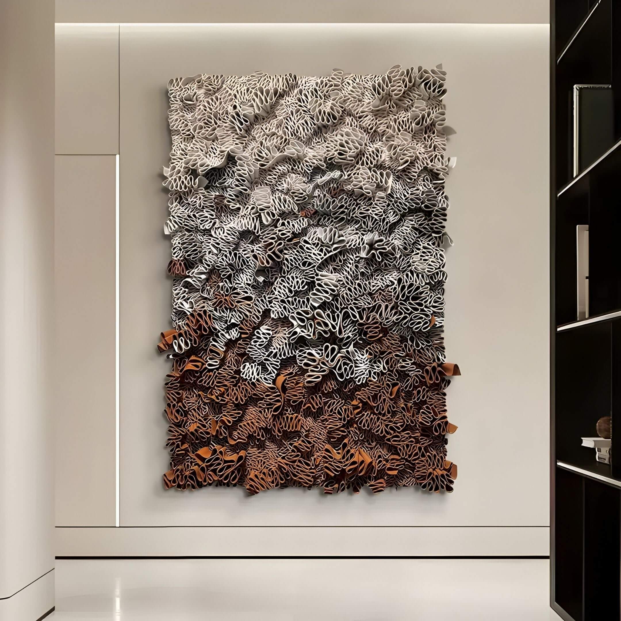 Liora Brown Ombre Ribbon Leather 3D Wall Art hanging on a modern interior hallway, showcasing layered leather ribbons in gradient brown, white, and black tones with sculptural depth.