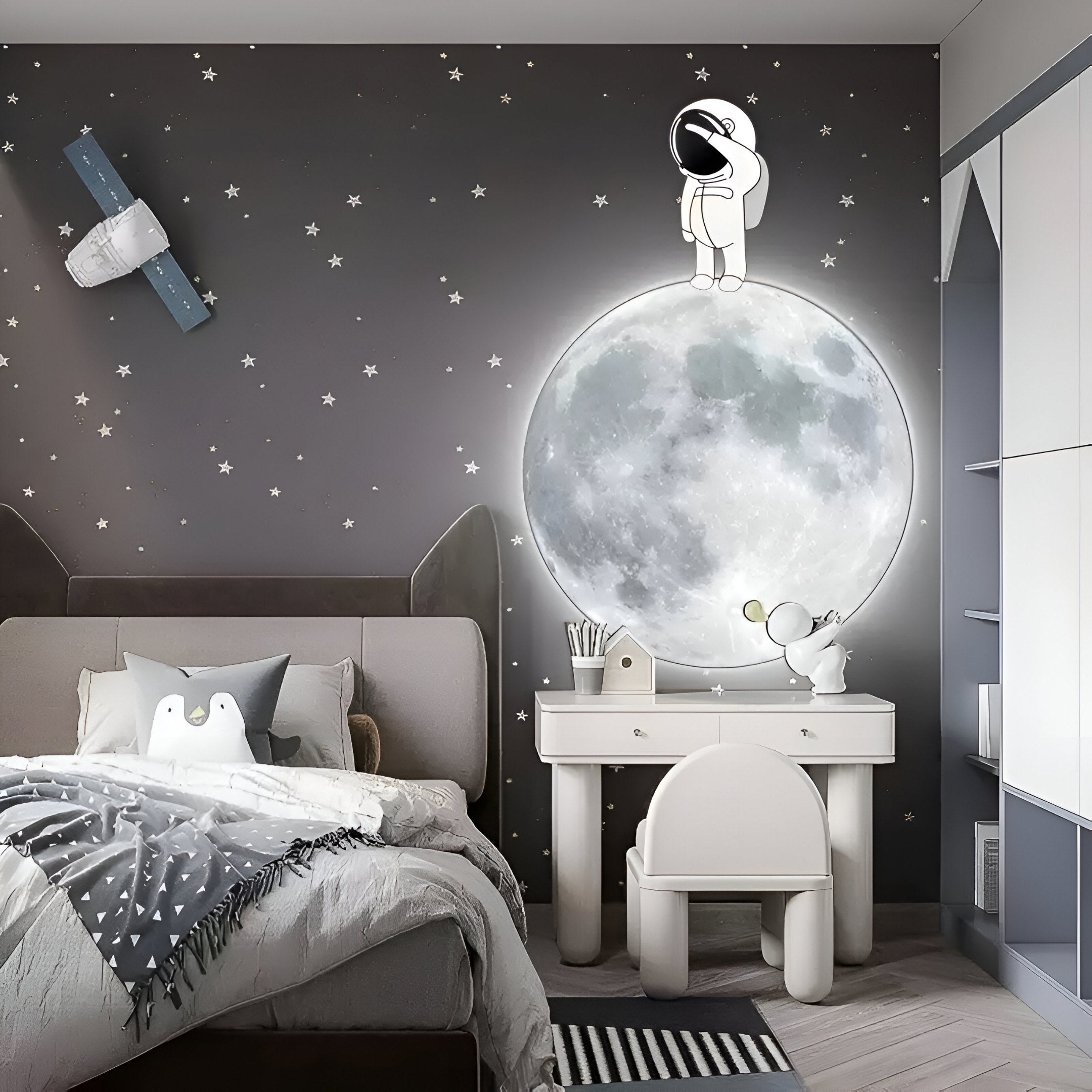Kids’ bedroom with glowing moon and astronaut wall art against a starry dark gray background.