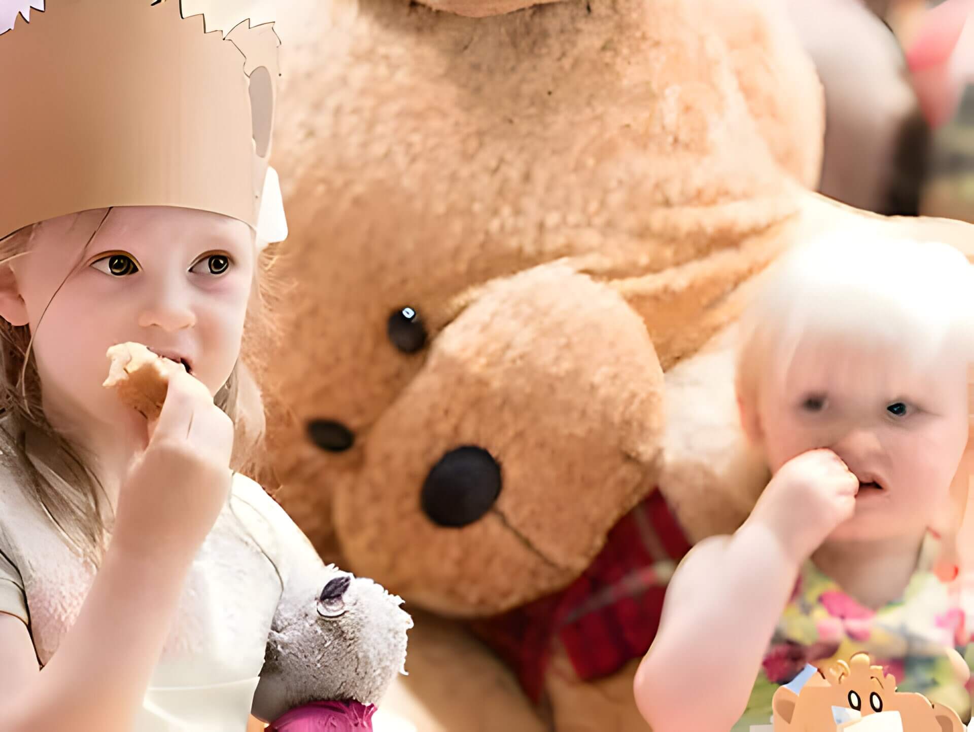2 children at a party eating sandwiches