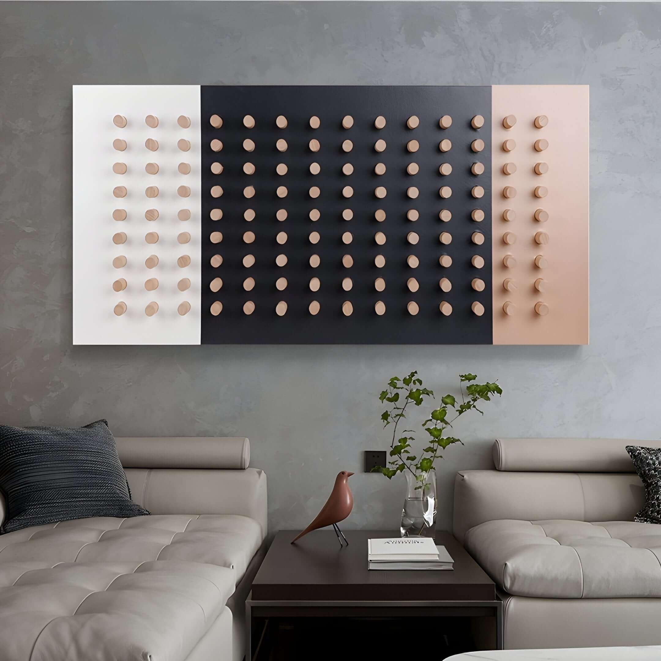 Monochrome and pastel geometric wall art with raised elements above a leather sofa.