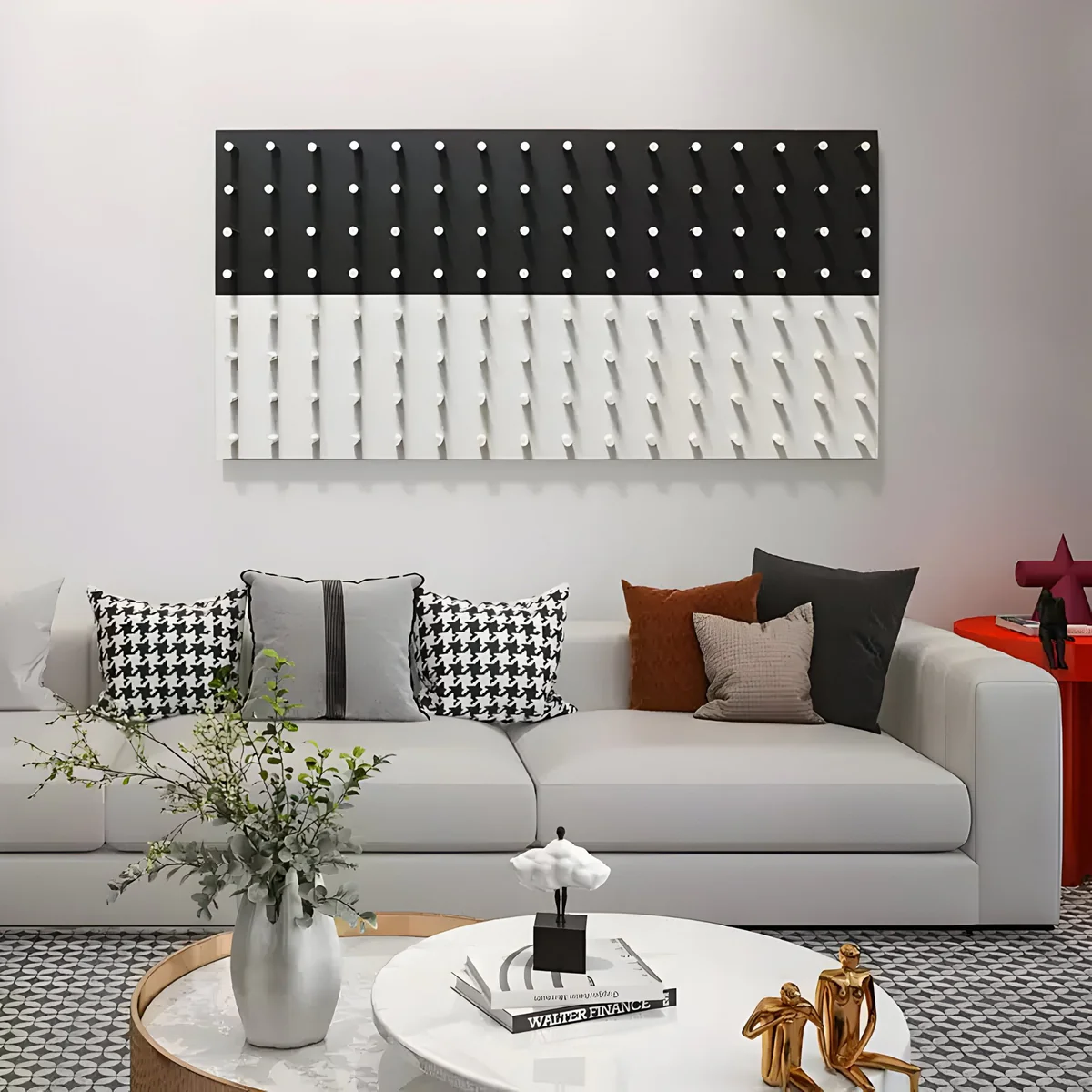 A stylish living room featuring a black and white 3D geometric wall art piece, a plush white sofa, and a combination of modern decorative pillows.