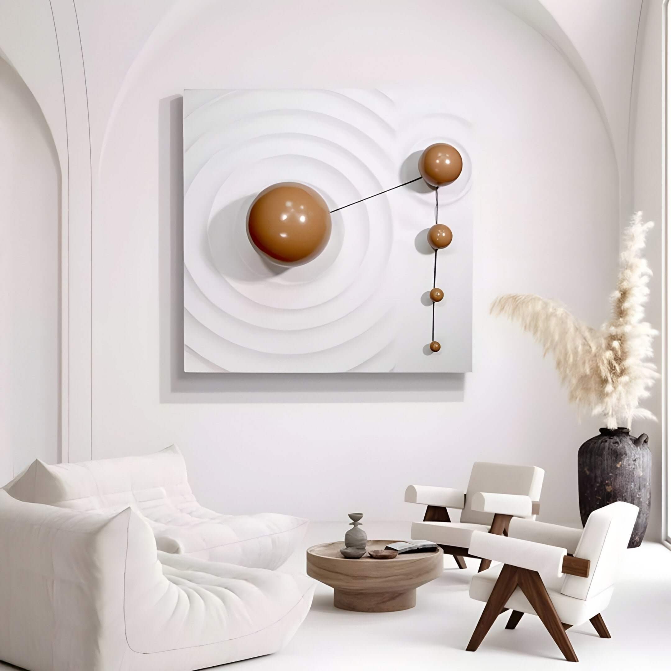 A minimalist living room features white furniture and the Galactica White Wood Relief 3D Wall Art with brown metal ball by Giant Sculptures. A vase with pampas grass complements a small round coffee table adorned with tasteful decor items.