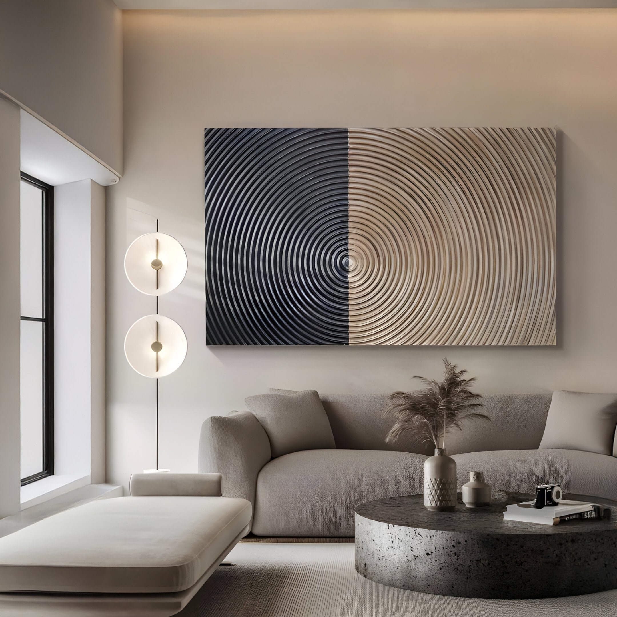 A modern living room features a light grey sofa, matching ottoman, round coffee table, and tall floor lamp. Above the sofa hangs Giant Sculptures Artura Beige & Black Hand-Painted 3D Relief Wall Art, enhancing the calm Wabi-Sabi-inspired decor.