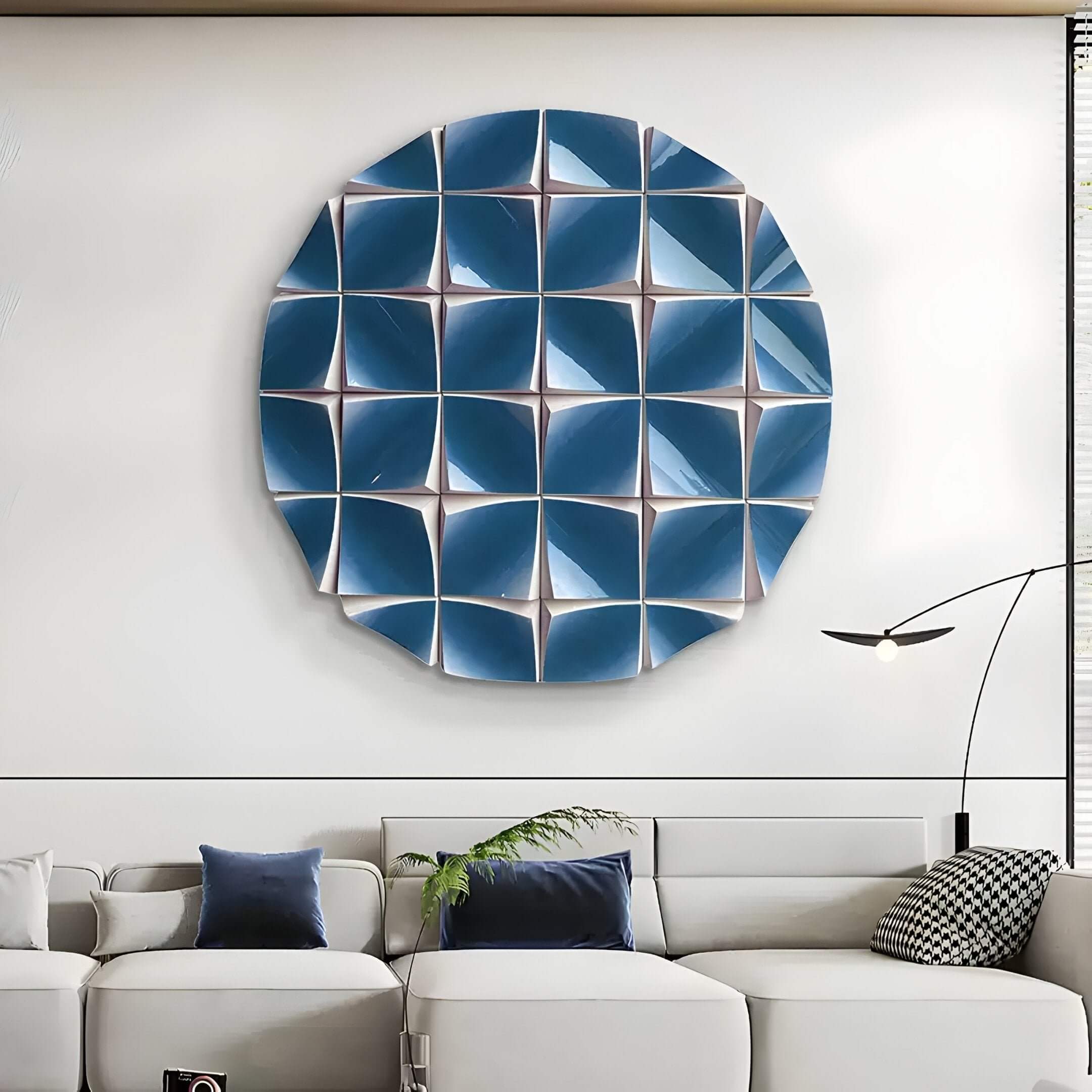 A modern living room featuring a white sectional sofa, blue and gray accent pillows, a minimalist floor lamp, and the Incalia Blue Circular Geometric Wood Relief 3D Wall Art by Giant Sculptures for bold contemporary style.