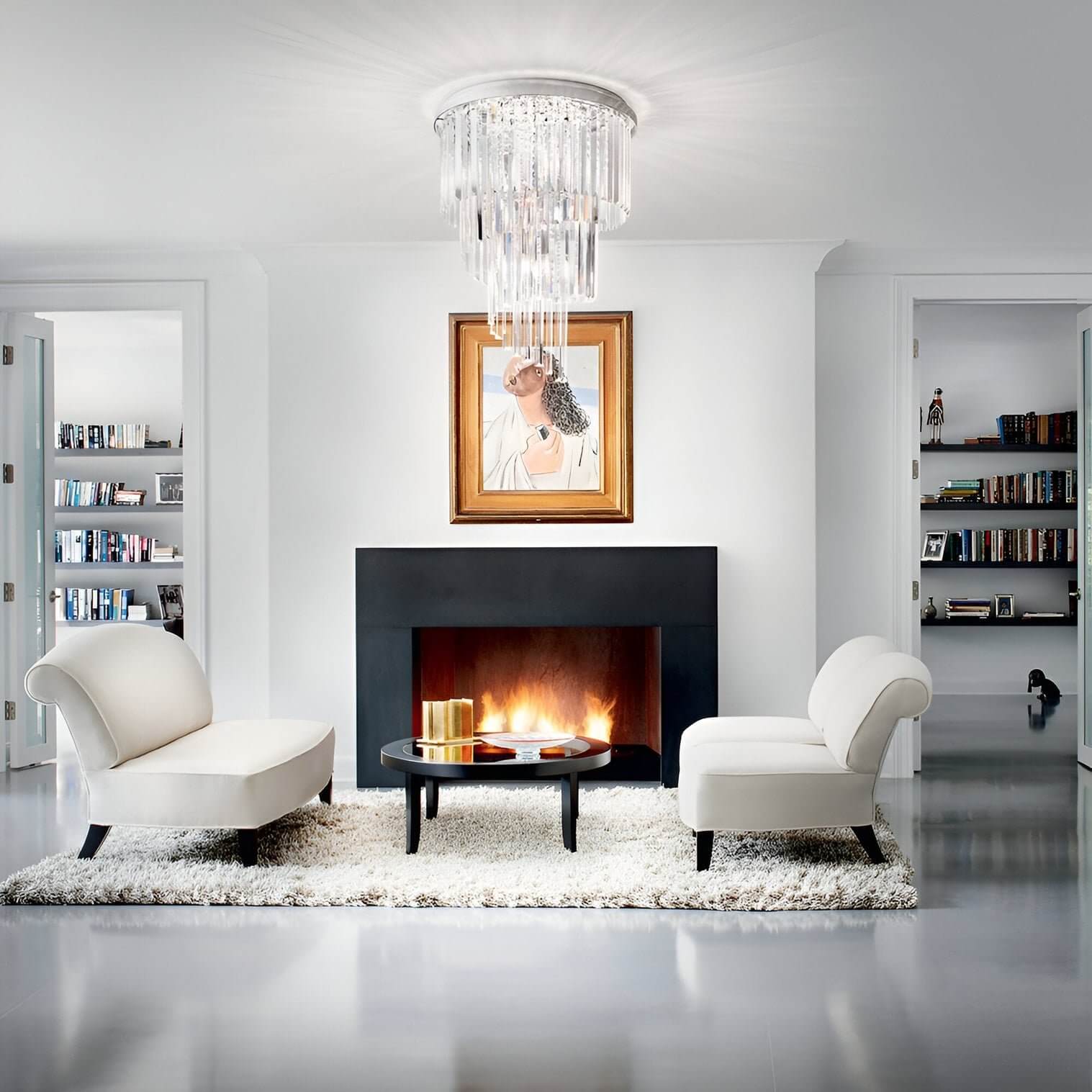 Tiered crystal flush mount chandelier in a minimal fireplace lounge with two sculptural armchairs.