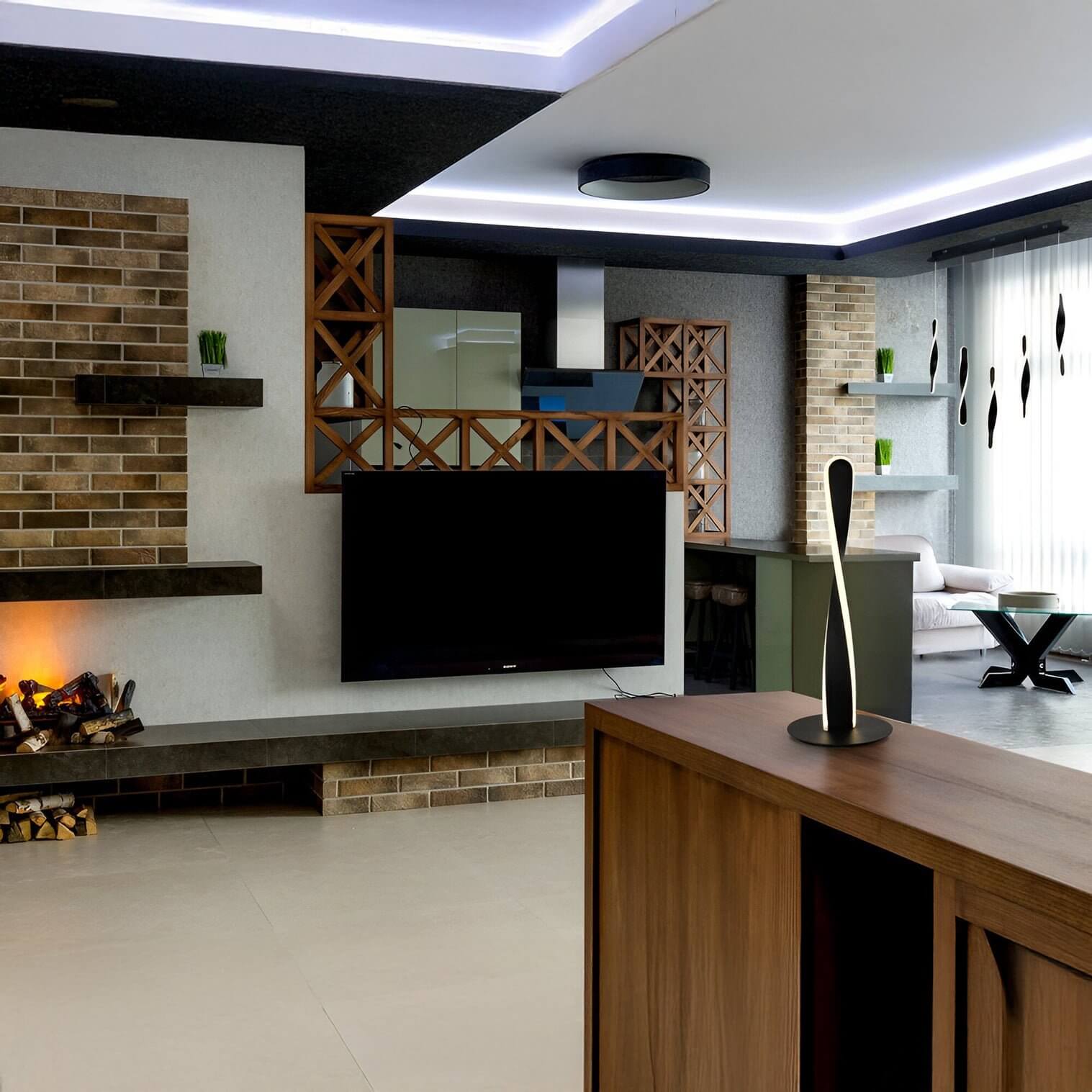 Industrial-style living kitchen with brick walls, geometric shelving, and sculptural LED table lamp.
