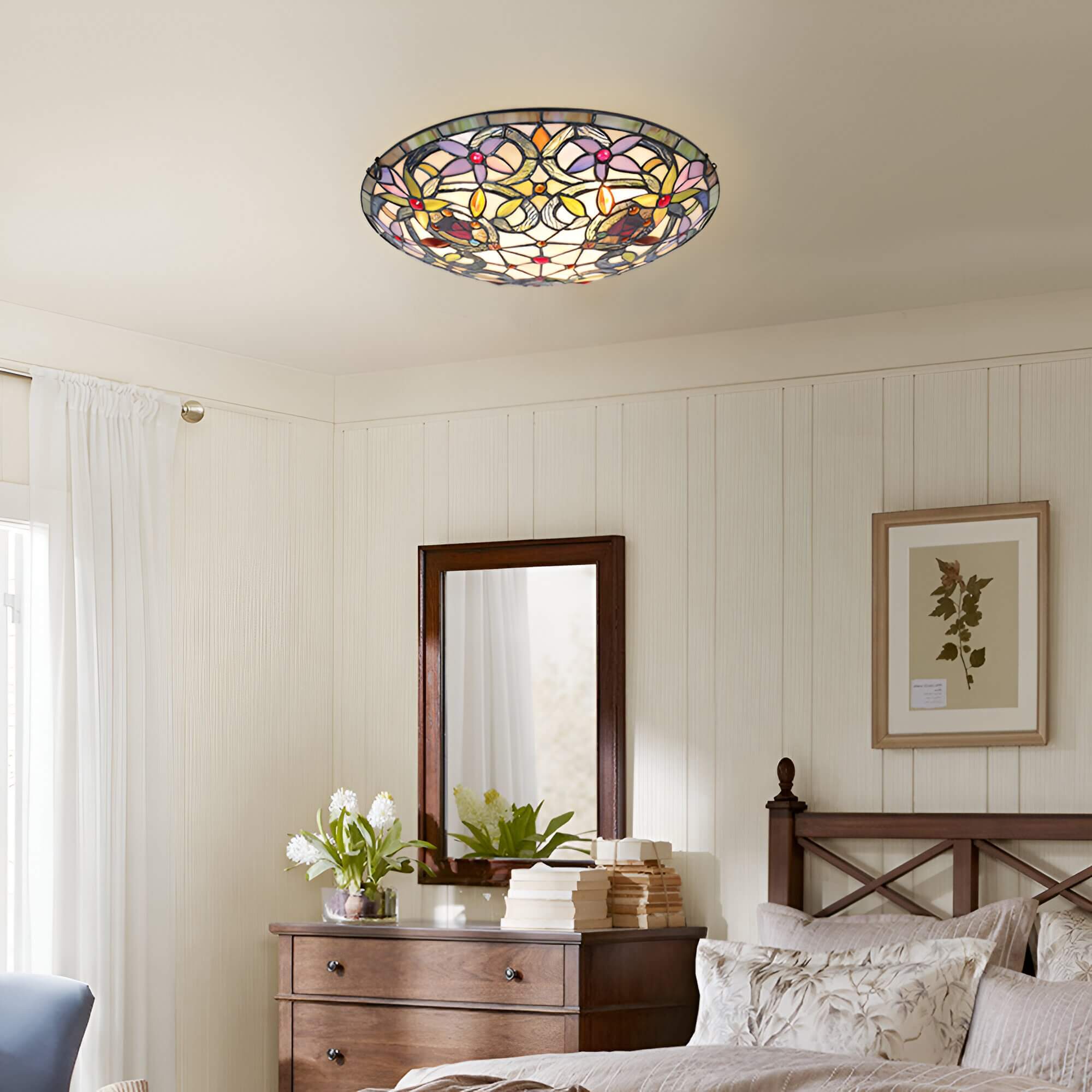 Colorful stained glass ceiling flush mount in a traditional bedroom with wooden furniture and white curtains
