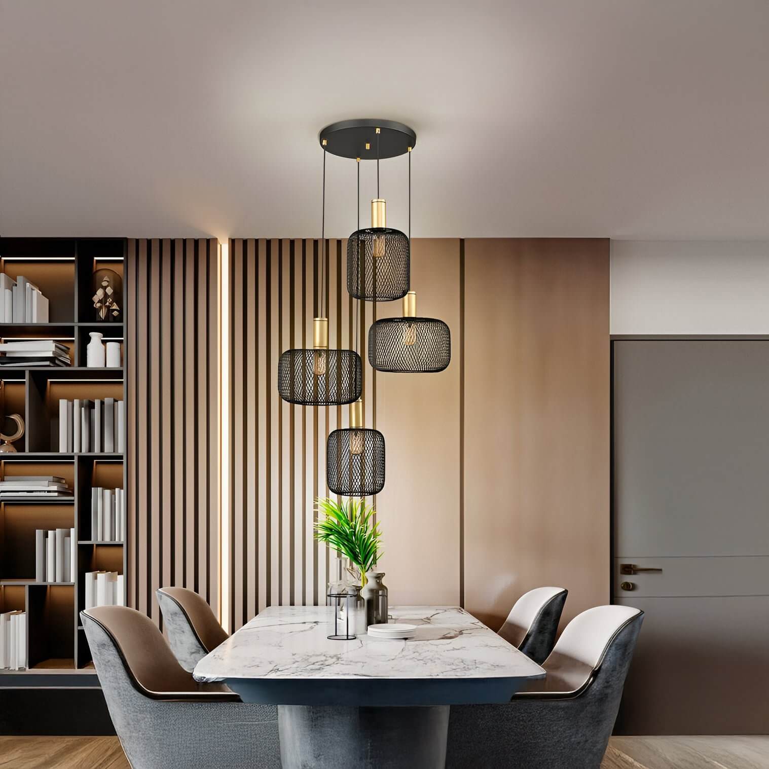 Cluster of black mesh pendant lights with exposed bulbs above a marble dining table.
