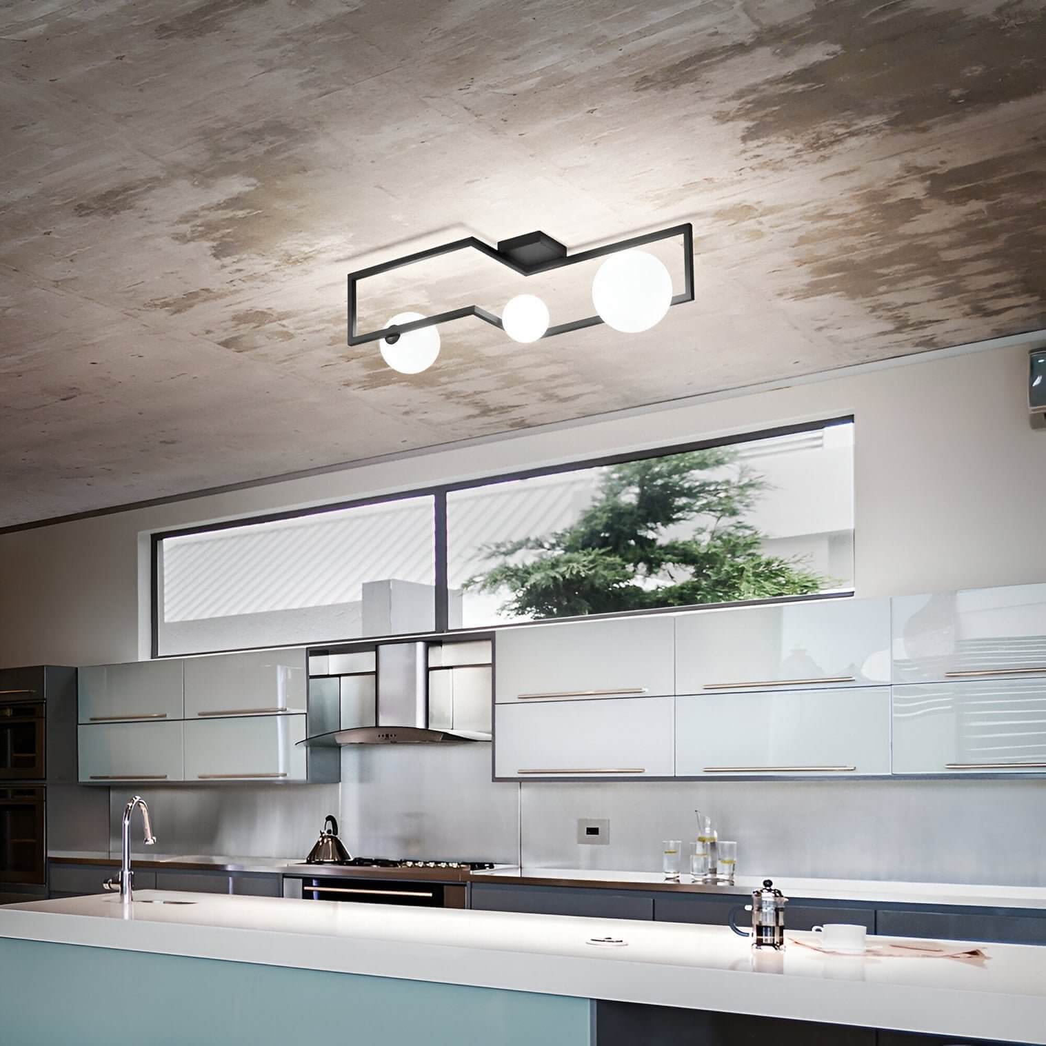 Modern kitchen with concrete ceiling, frosted cabinetry, and geometric black ceiling fixture with globe bulbs