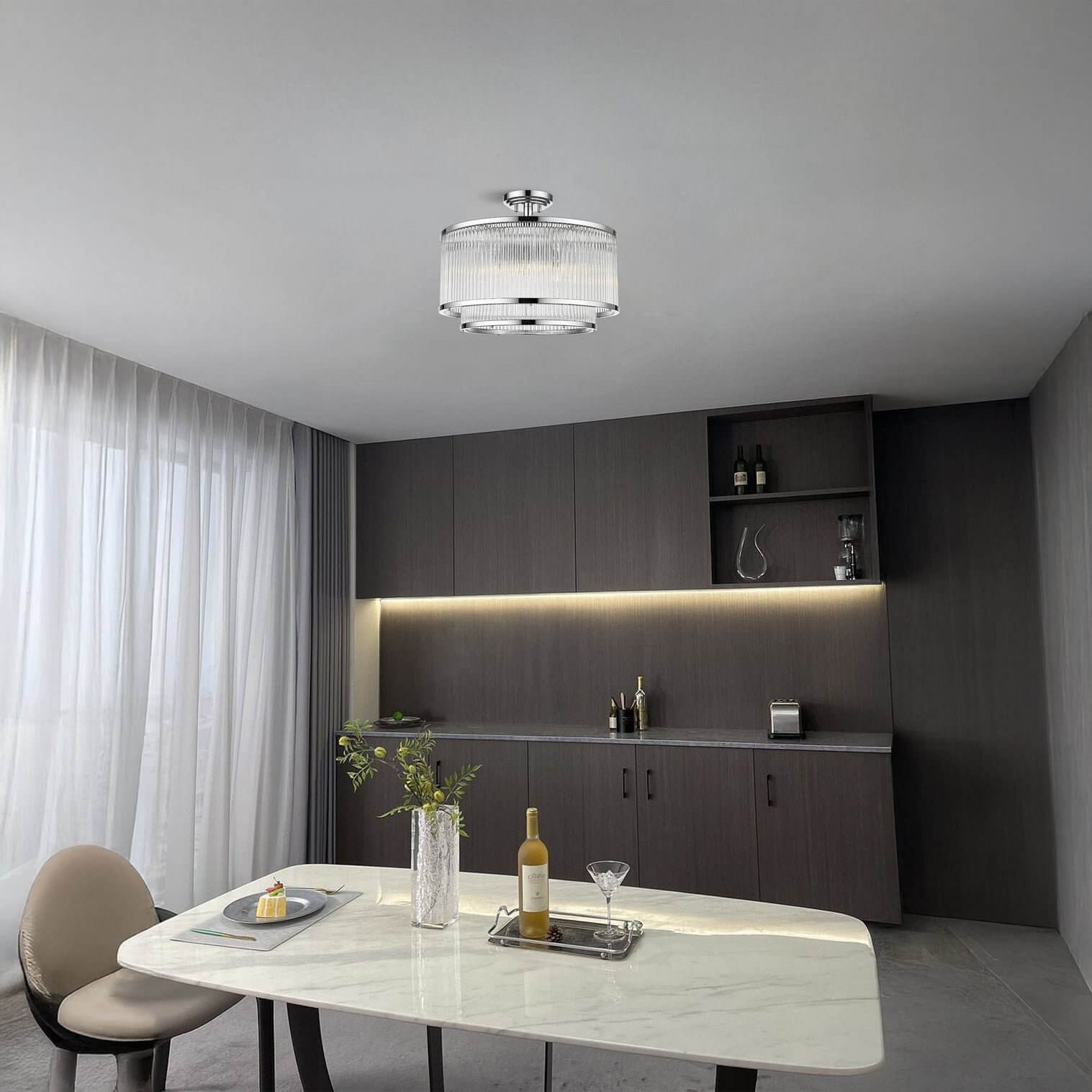 Chrome drum flush mount ceiling light with ribbed glass detail in a dining space.