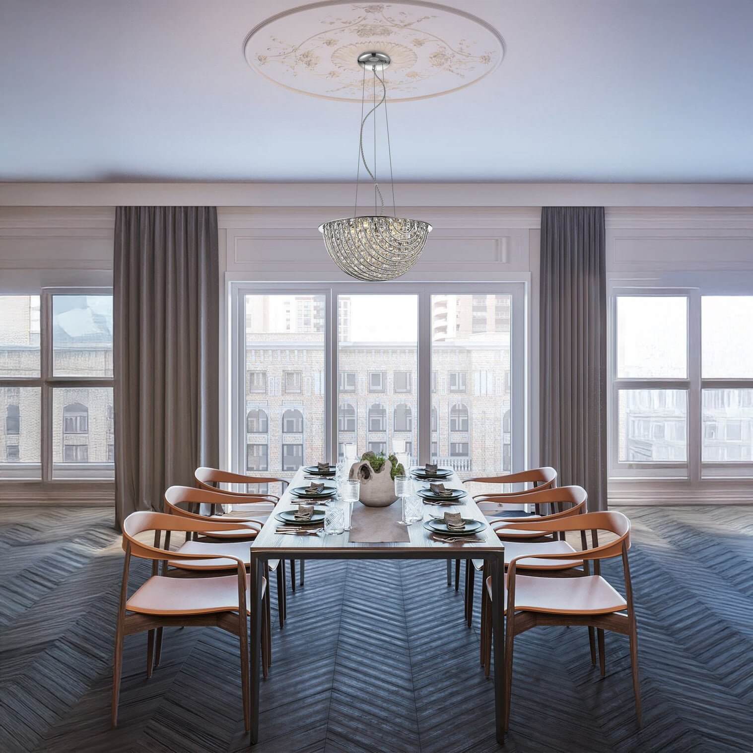 Elegant crystal bowl chandelier hanging in a bright dining room with long table.