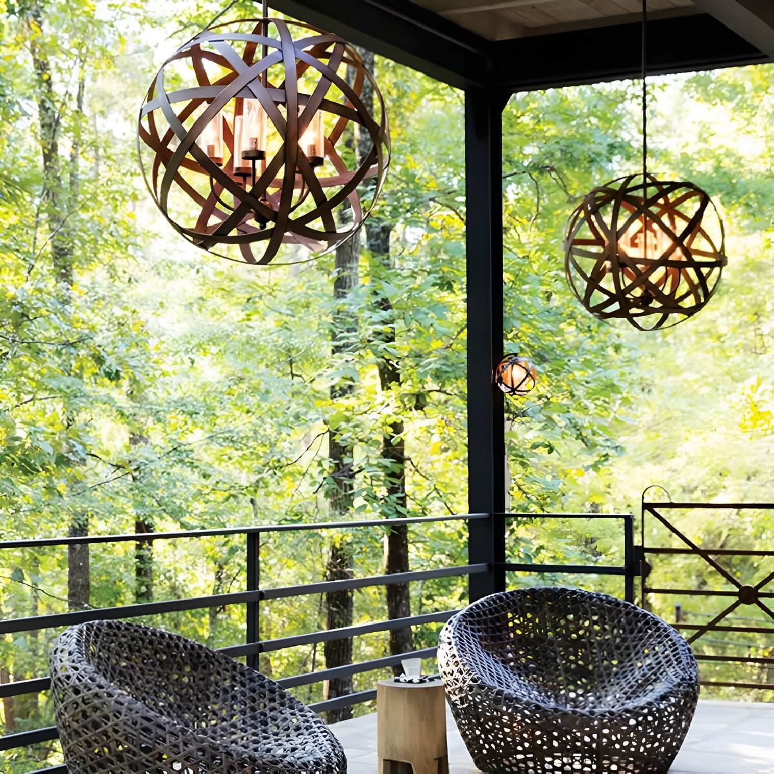 Pair of spherical wooden pendant lights with open lattice frames hanging over a forest-view balcony.