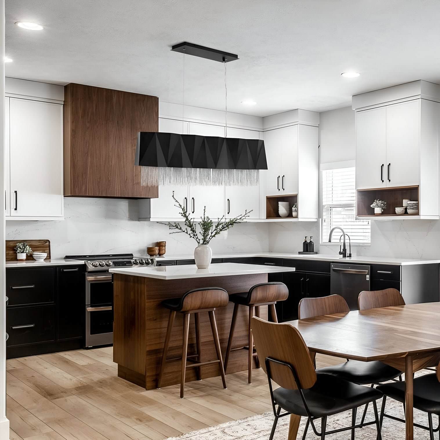 Long black rectangular pendant with fringe detail over a contemporary kitchen island.
