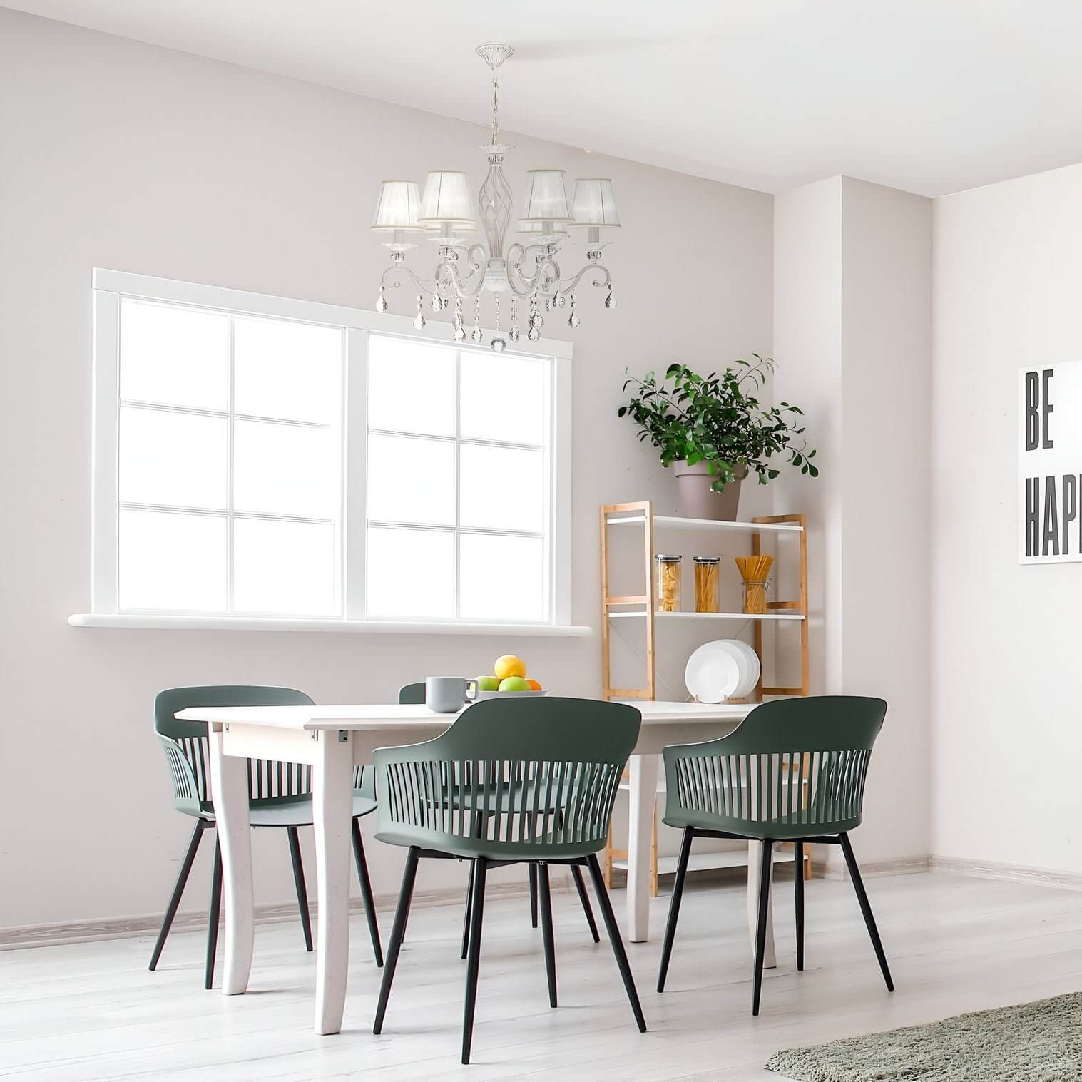 Elegant crystal chandelier with white shades hanging above a modern dining table.