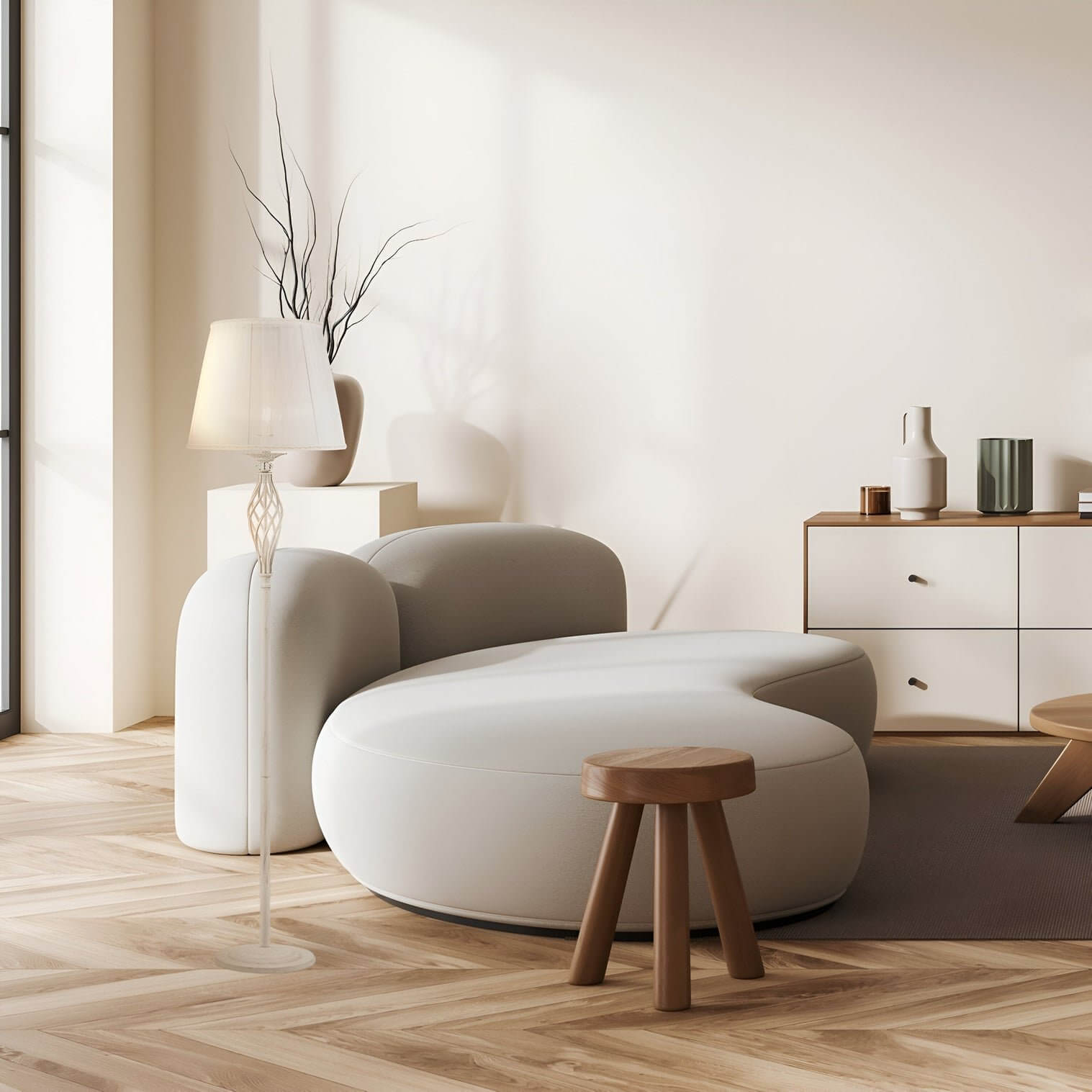 White floor lamp with a fluted base and fabric shade stands beside a sculptural sofa in a pale-toned, minimalist living room.