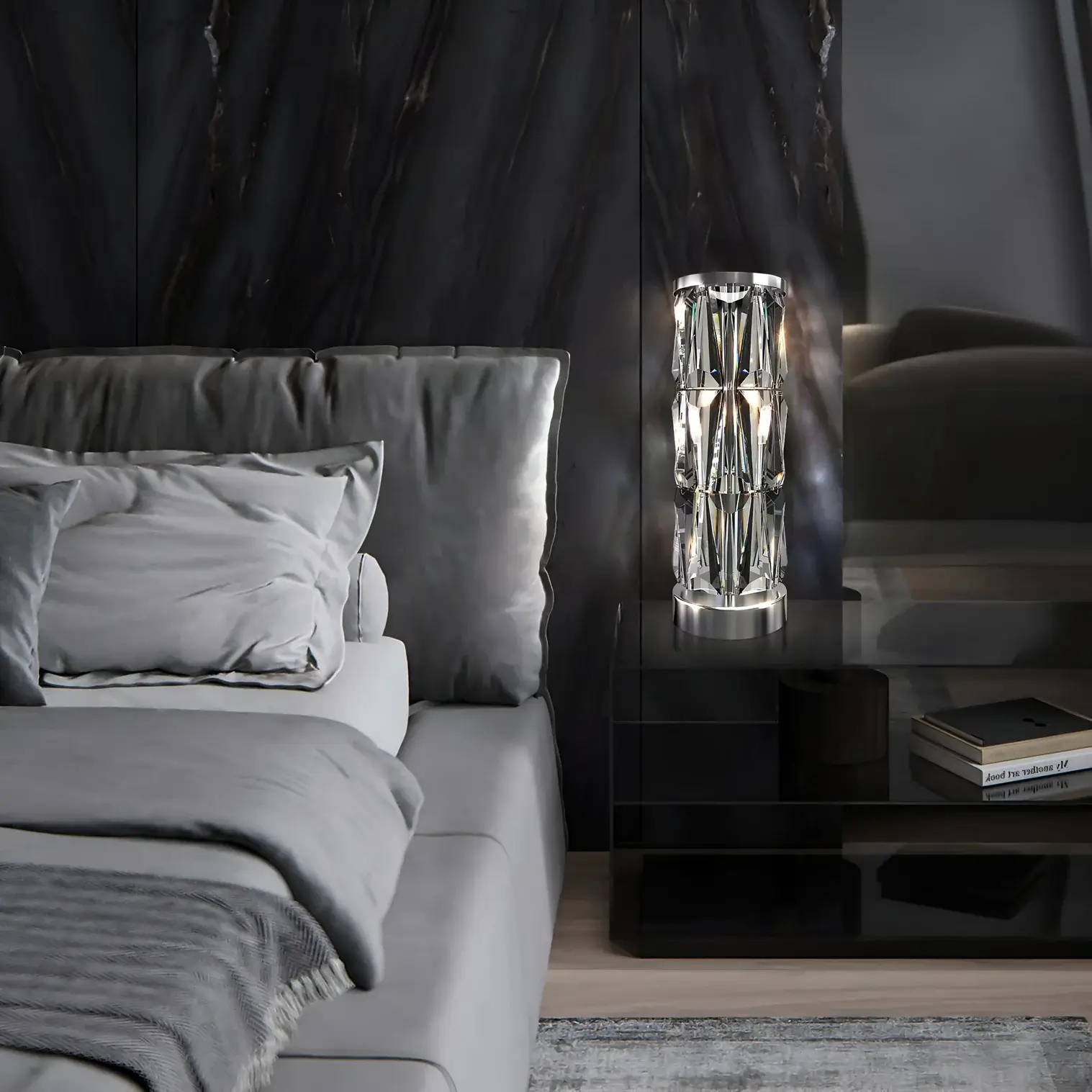 A luxurious bedroom featuring a sleek black bedside table adorned with a crystal table lamp emitting a warm glow, paired with grey bedding and a dark, textured wall.