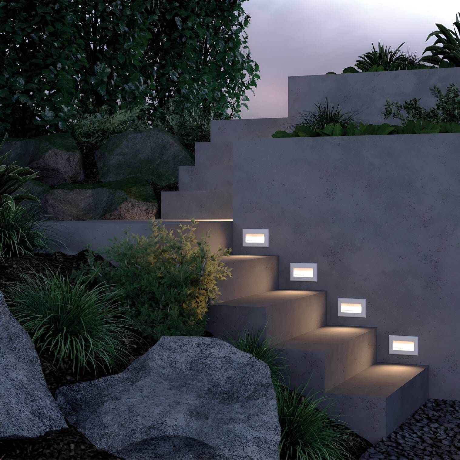 Concrete outdoor stairs with square recessed lights spaced along the risers surrounded by greenery and rocks.