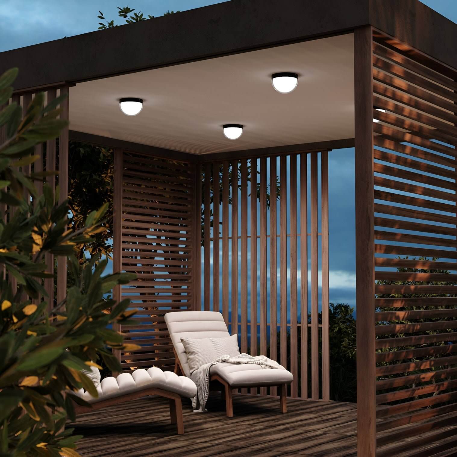Wooden pergola with recessed dome lights above cushioned loungers and lush plants at dusk.