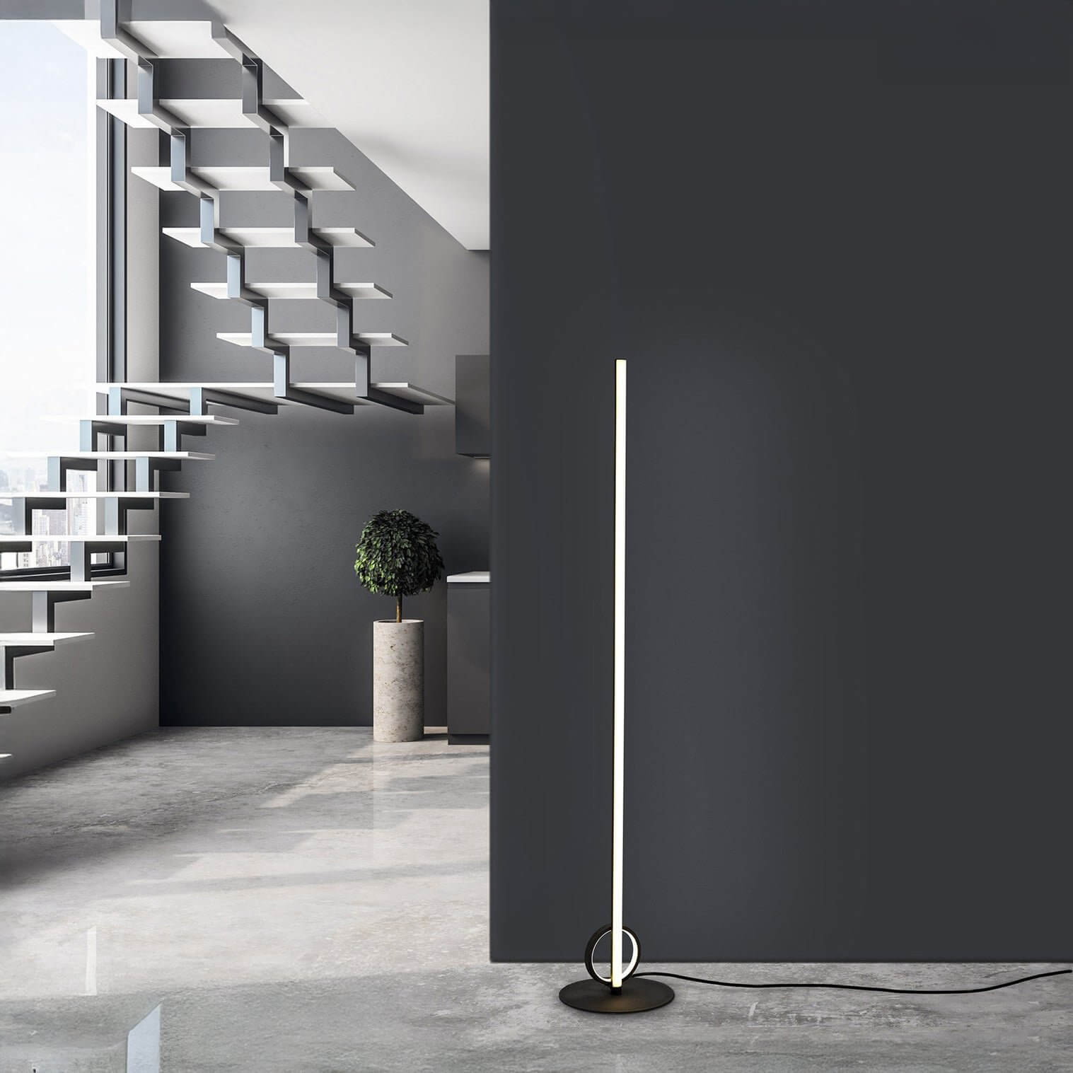 Ultra-slim vertical LED floor lamp with circular base against a dark feature wall.