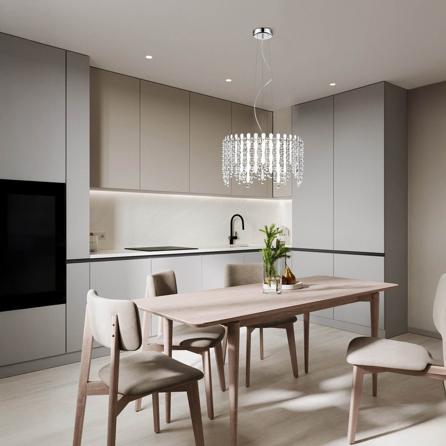 Contemporary dining area with a crystal chandelier adding sparkle above a light wood table.