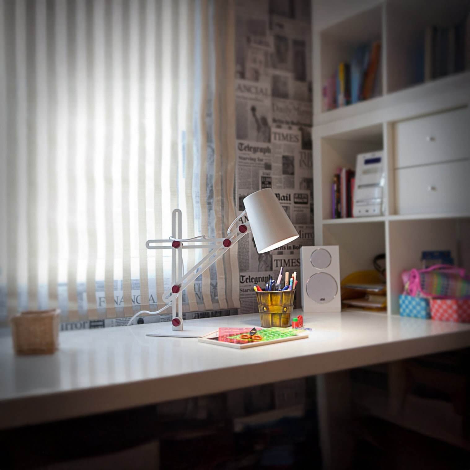 Adjustable white desk lamp with red accents on a bright work table by a window.