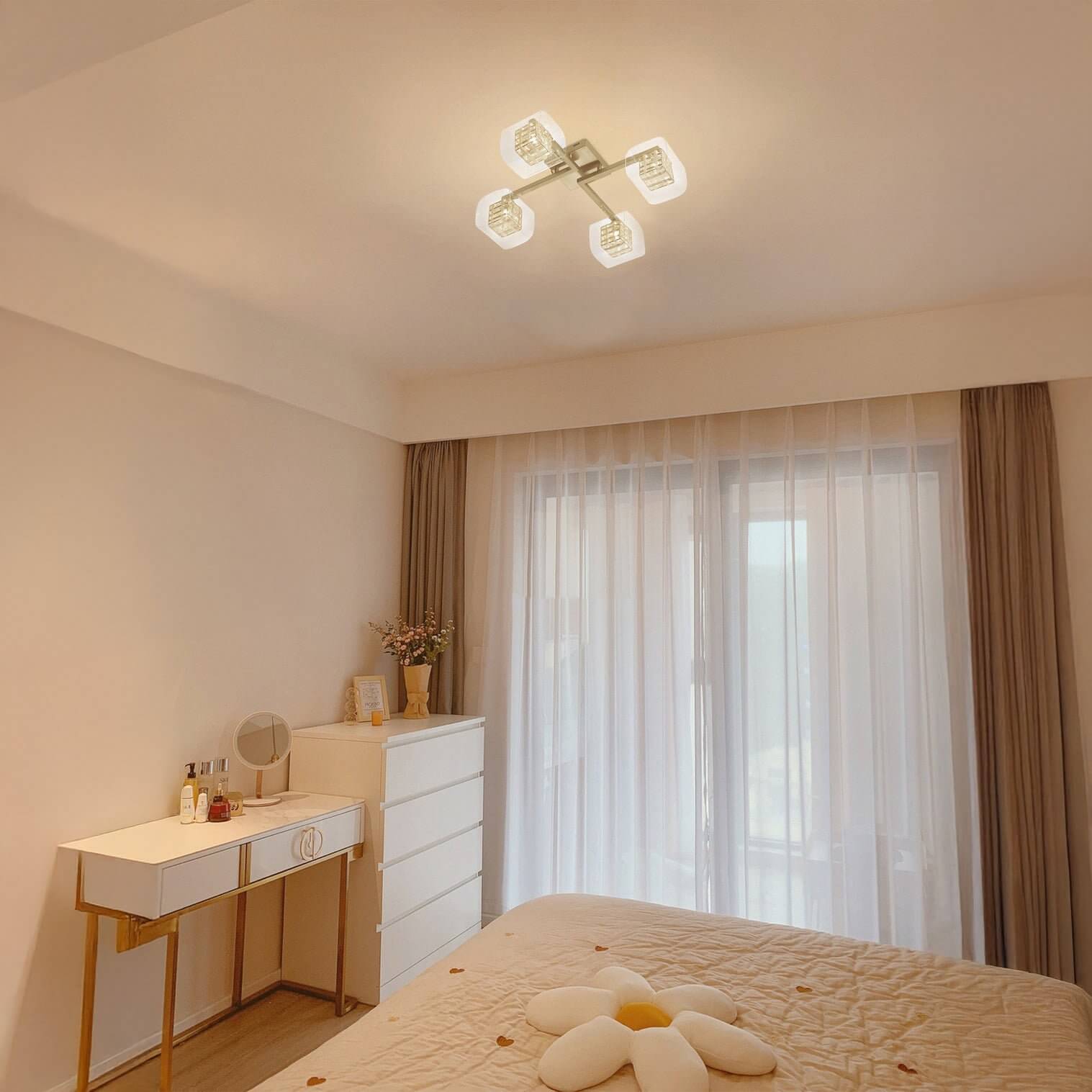 Square four-light ceiling fixture with frosted shades in a bright bedroom.