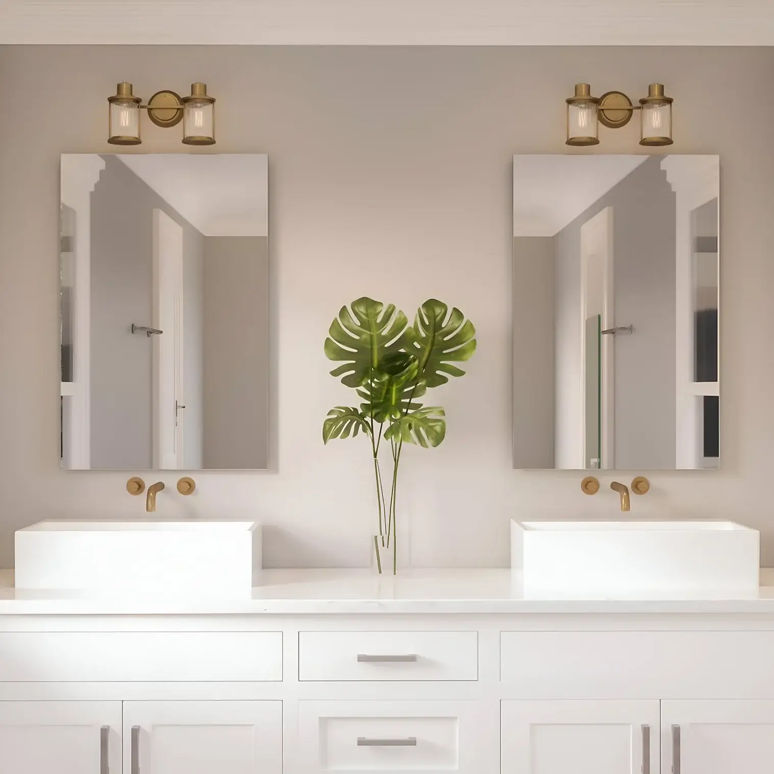 Elegant vanity with dual square sinks, gold hardware, and soft lighting, accented by a leafy green plant between mirrors.