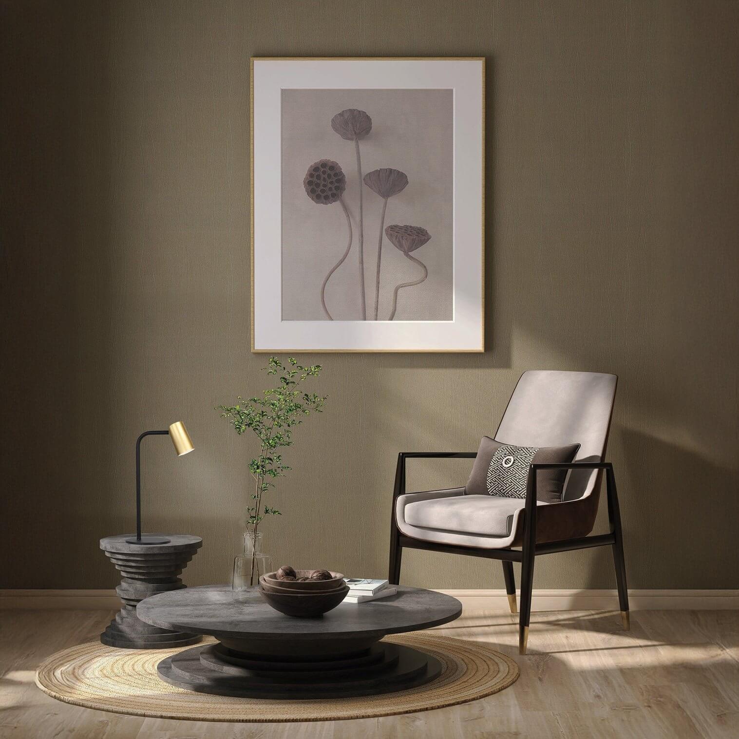Minimalist black and gold accent lamp on a round side table in a modern living space.